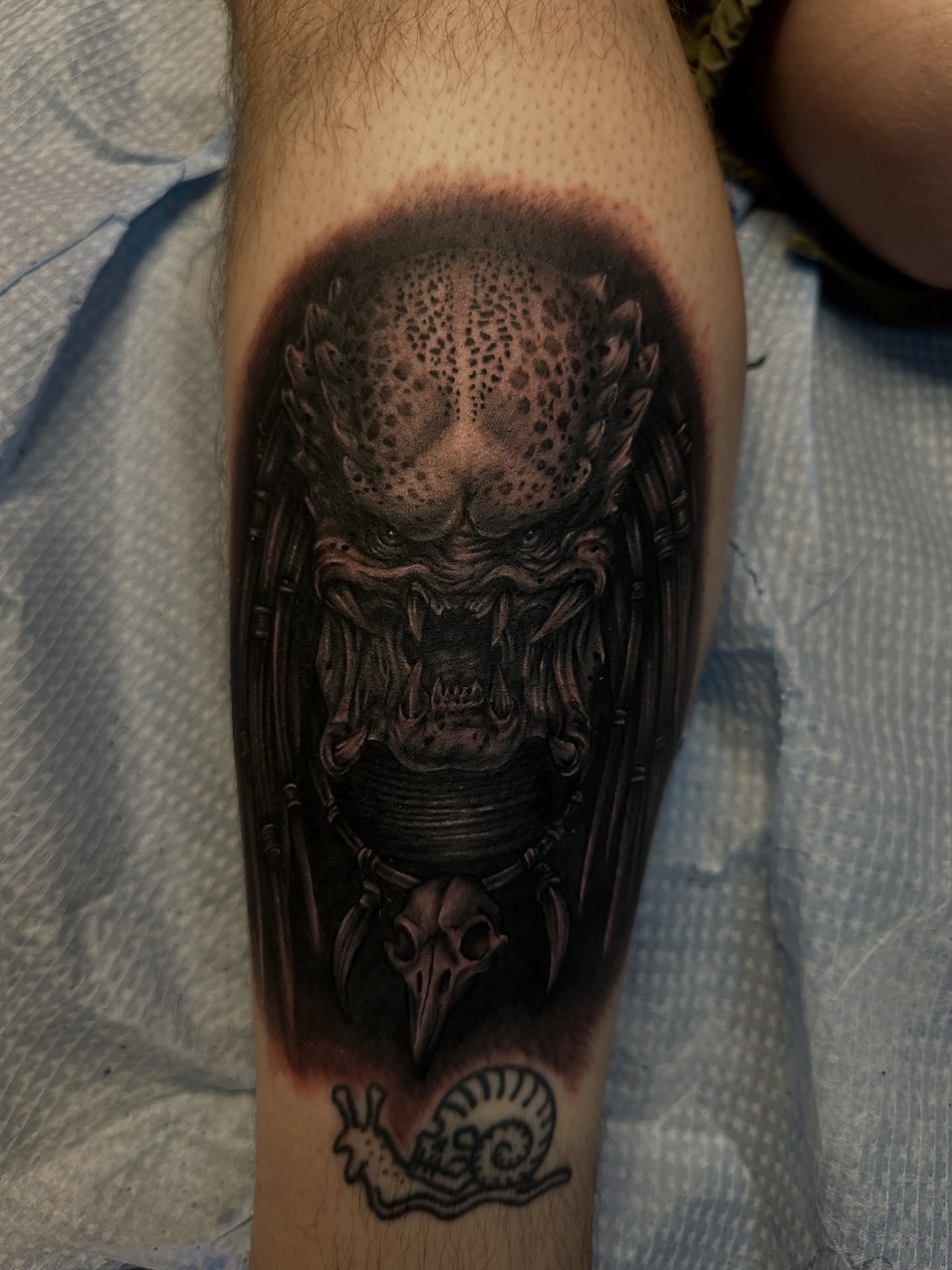 Predator mask dark realism tattoo on the forearm by Holle Hellfire