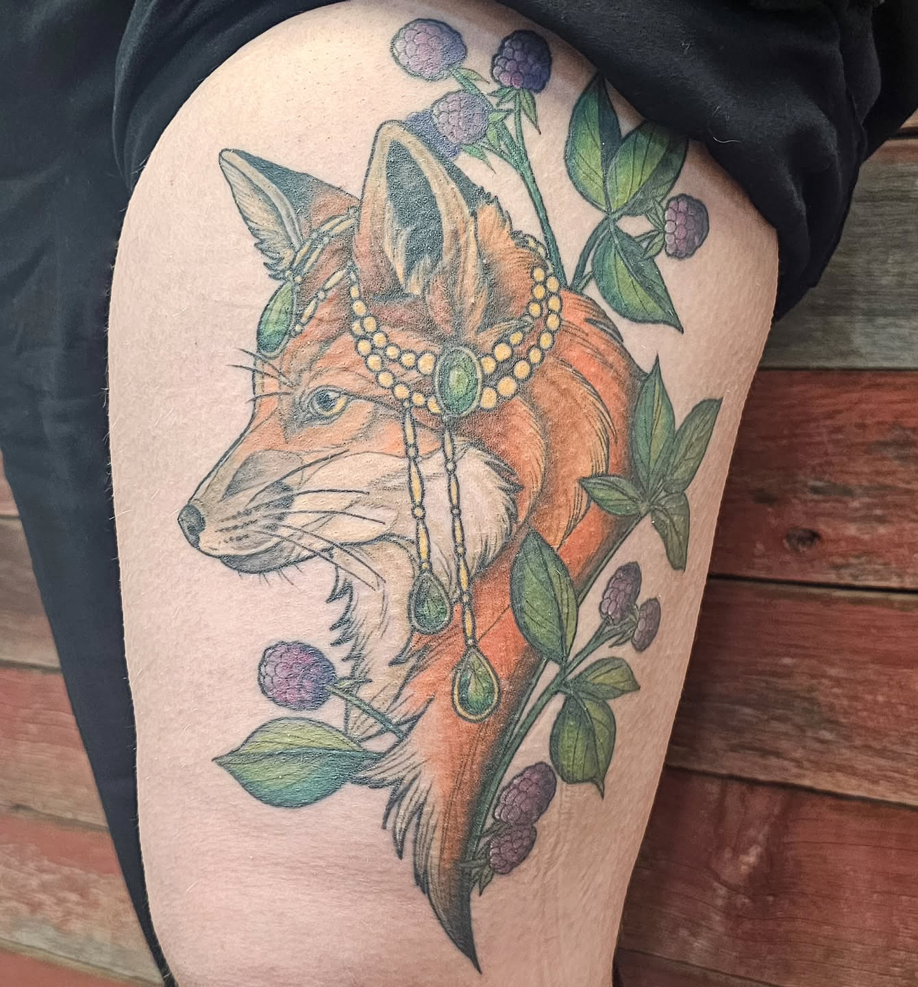 Fox with floral crown realism tattoo on the thigh by Savannah
