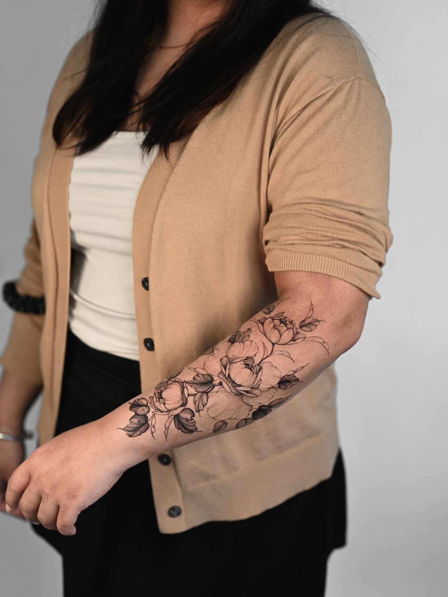 Floral bouquet black and grey tattoo on the forearm by Anastasiia