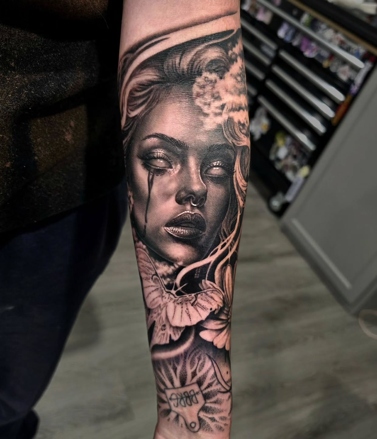 Woman's face realism tattoo on the forearm by Julia Oravets
