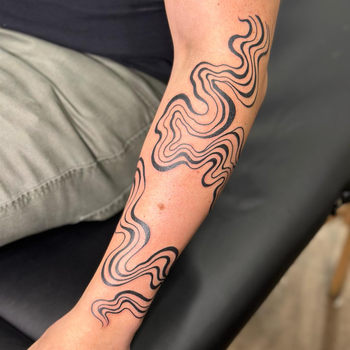 Swirl pattern black and grey tattoo on the forearm by Alexa Wolfkiel