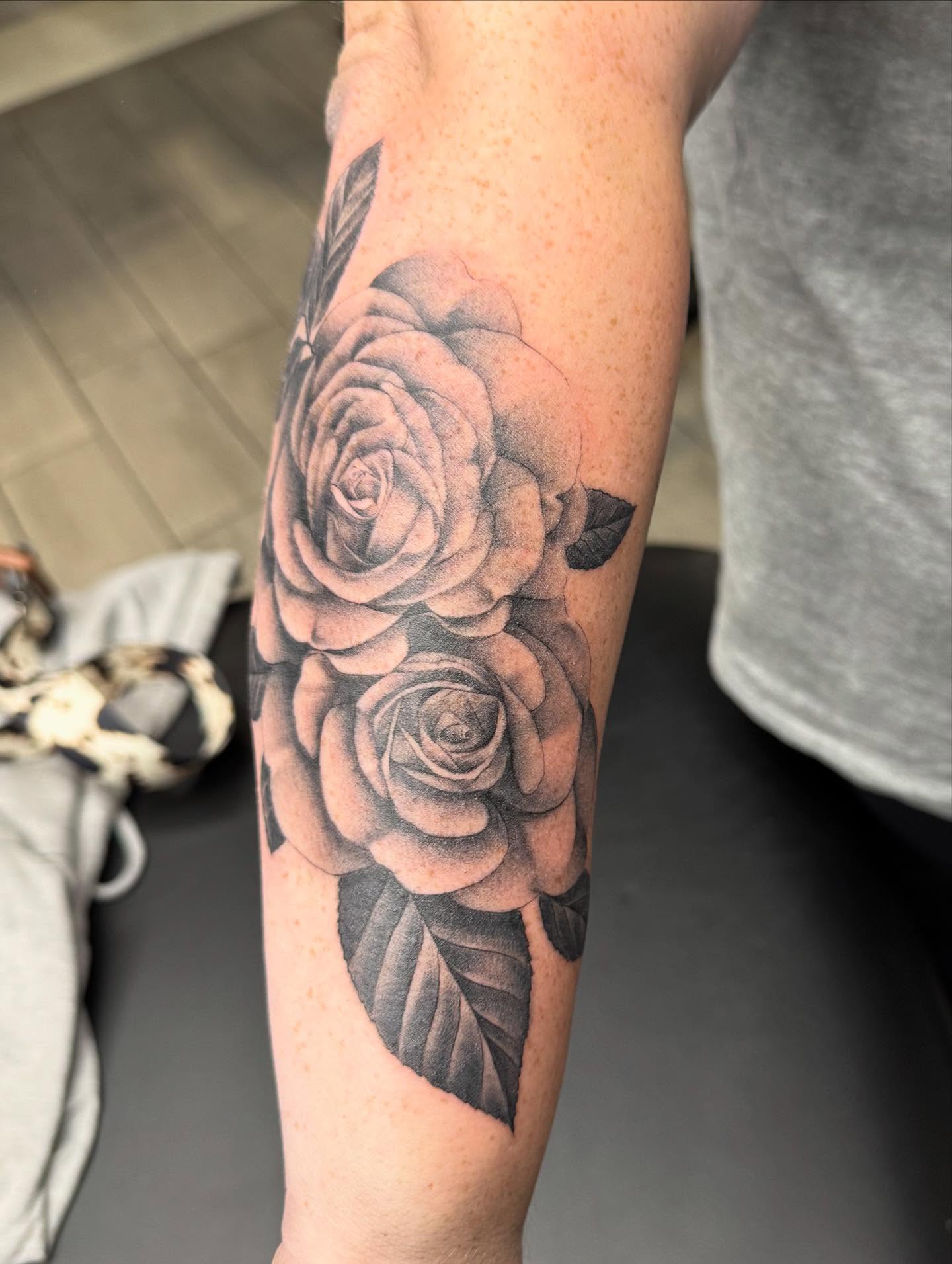 Roses realism tattoo on the forearm by Joey Flaherty