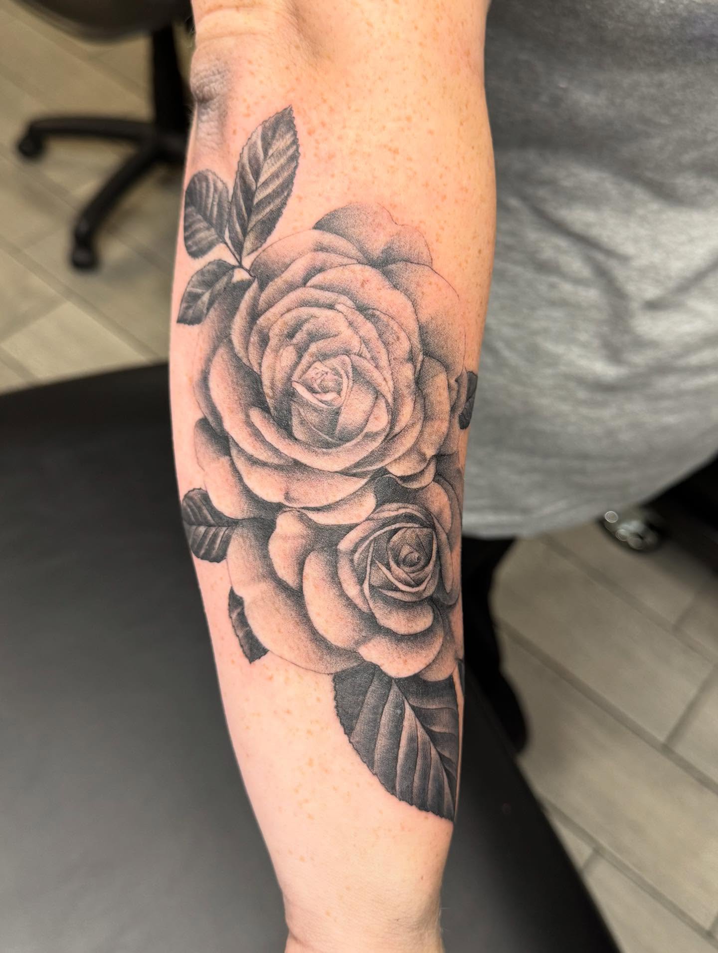 Roses black and grey tattoo on the forearm by Joey Flaherty