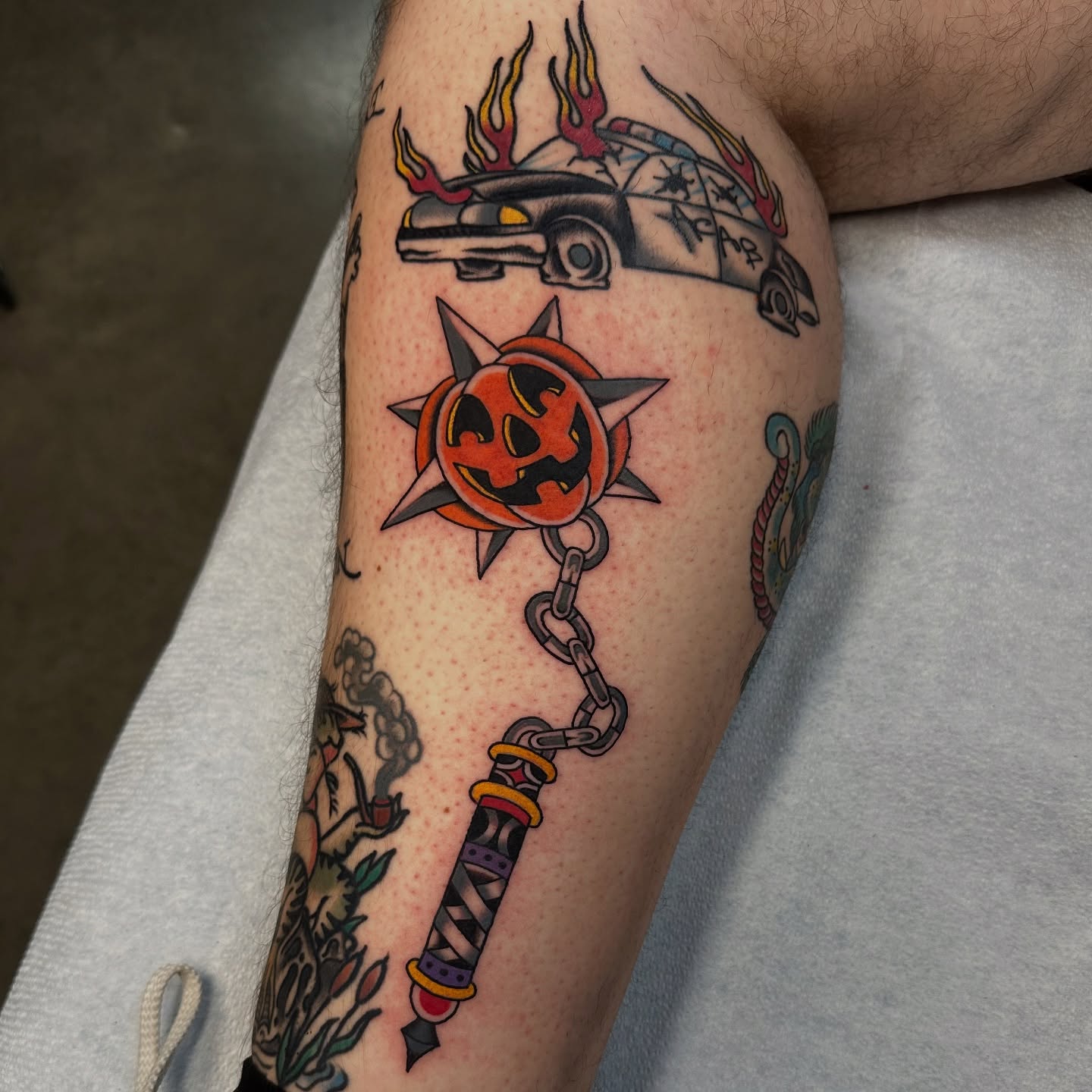 Pumpkin and sword American traditional tattoo on the forearm by Emily Masa