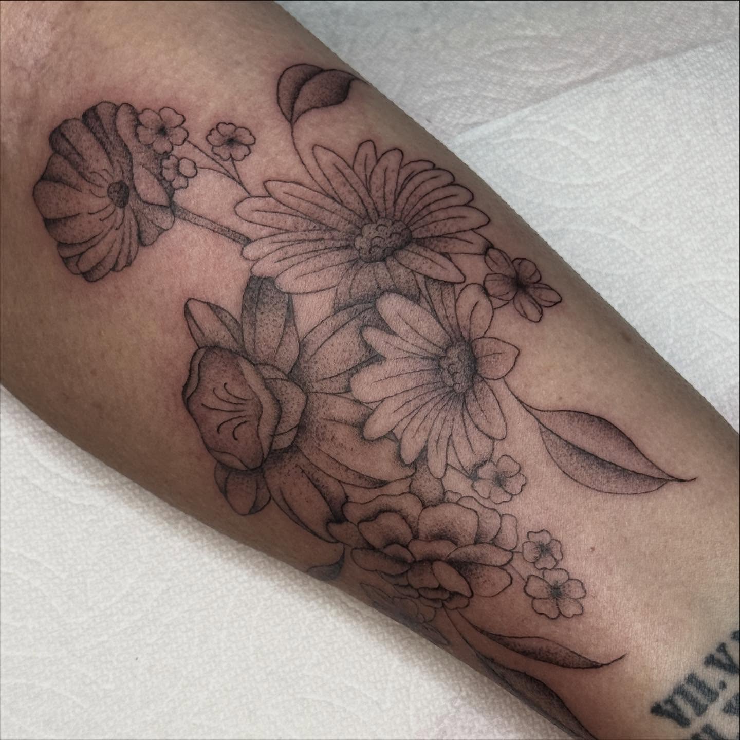 Floral bouquet black and grey tattoo on the forearm by chloe jeanel estrada