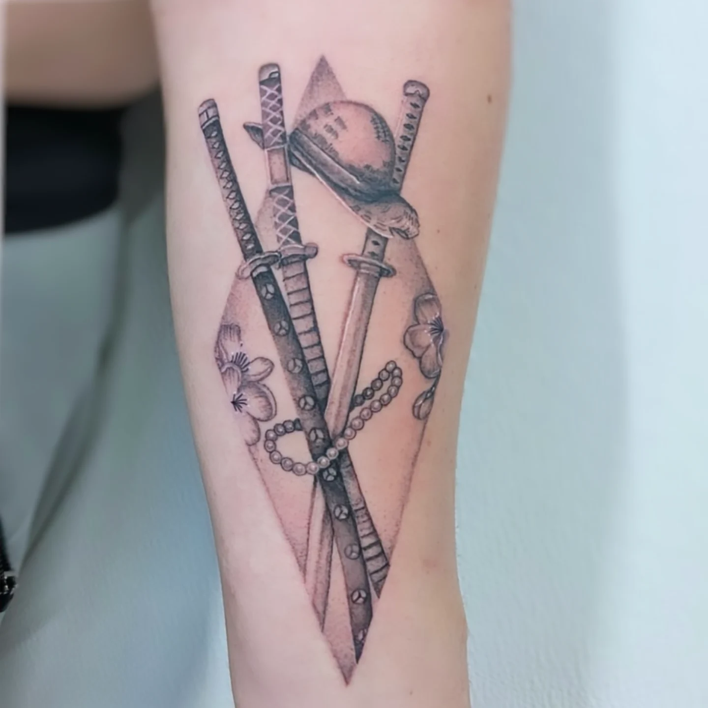 Katana and helmet realism tattoo on the forearm by Deborah
