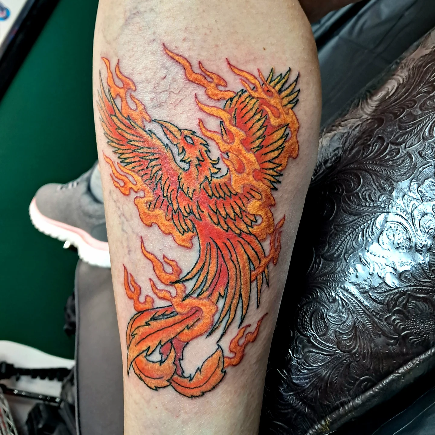 Flaming phoenix neo-traditional tattoo on the forearm by Reb Fularz