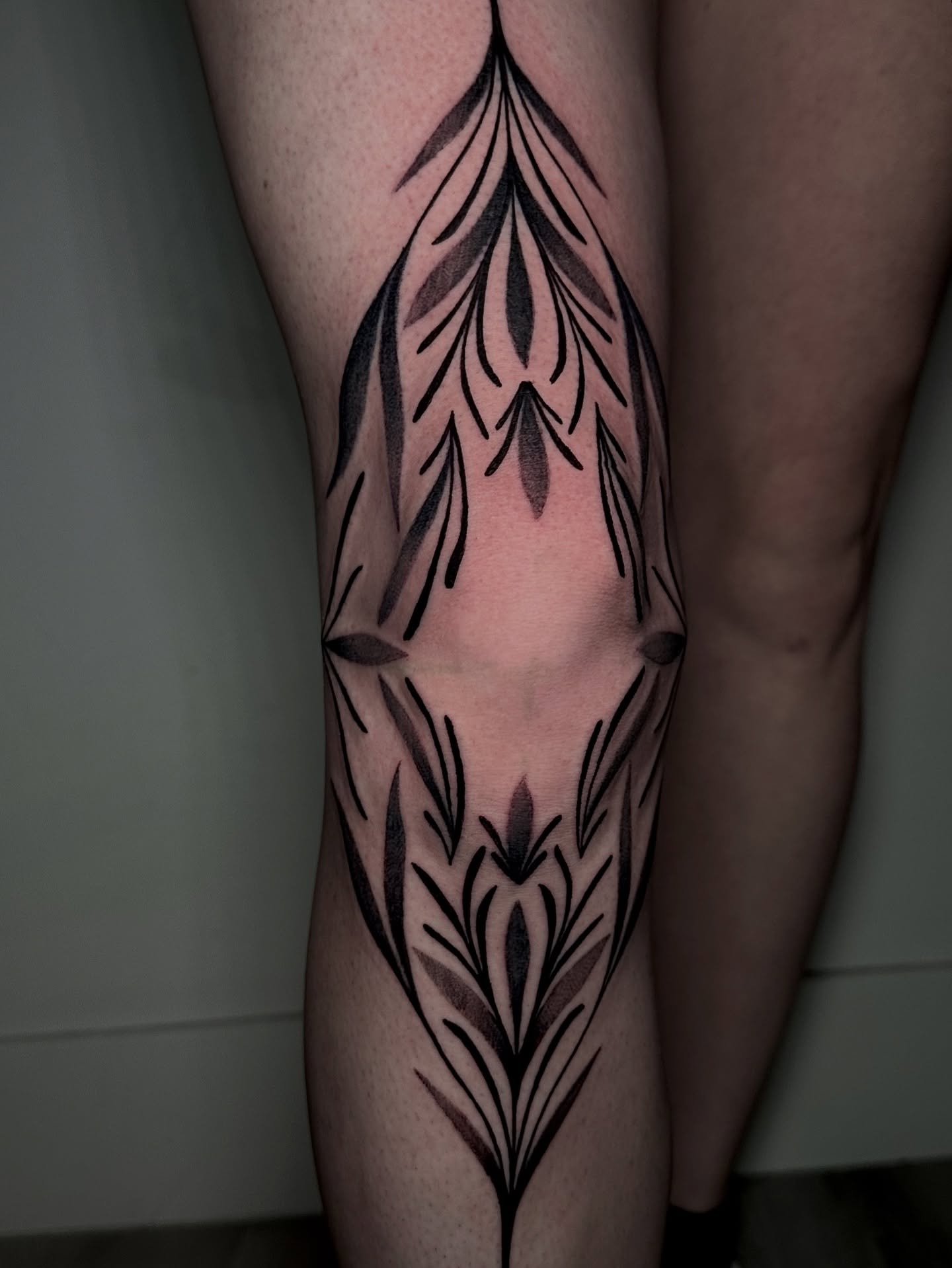 Feather geometric tattoo on the calf by Crystal, Las Vegas, Nevada