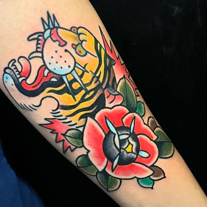 Tiger and flower American traditional tattoo on the forearm by Sirvonesmithtattoos@gmail.com