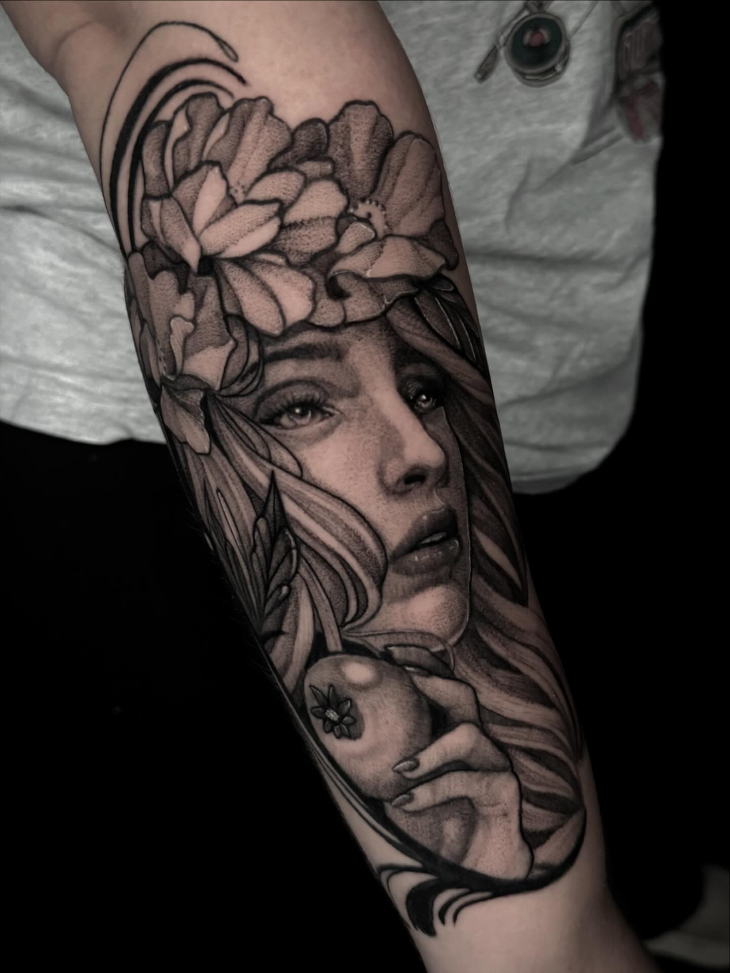 Woman with flowers realism tattoo on the forearm by Mandi Marie, Charlotte, North Carolina