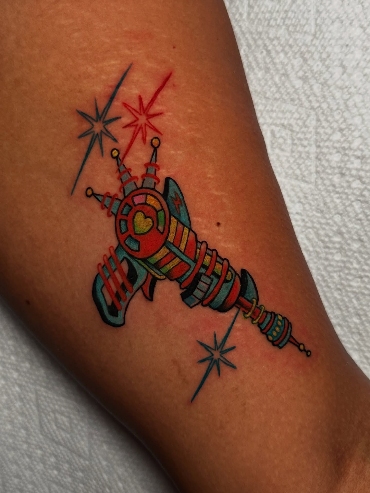 Space-themed weapon new school tattoo on the forearm by Tayler Pearson, Fort Collins, Colorado