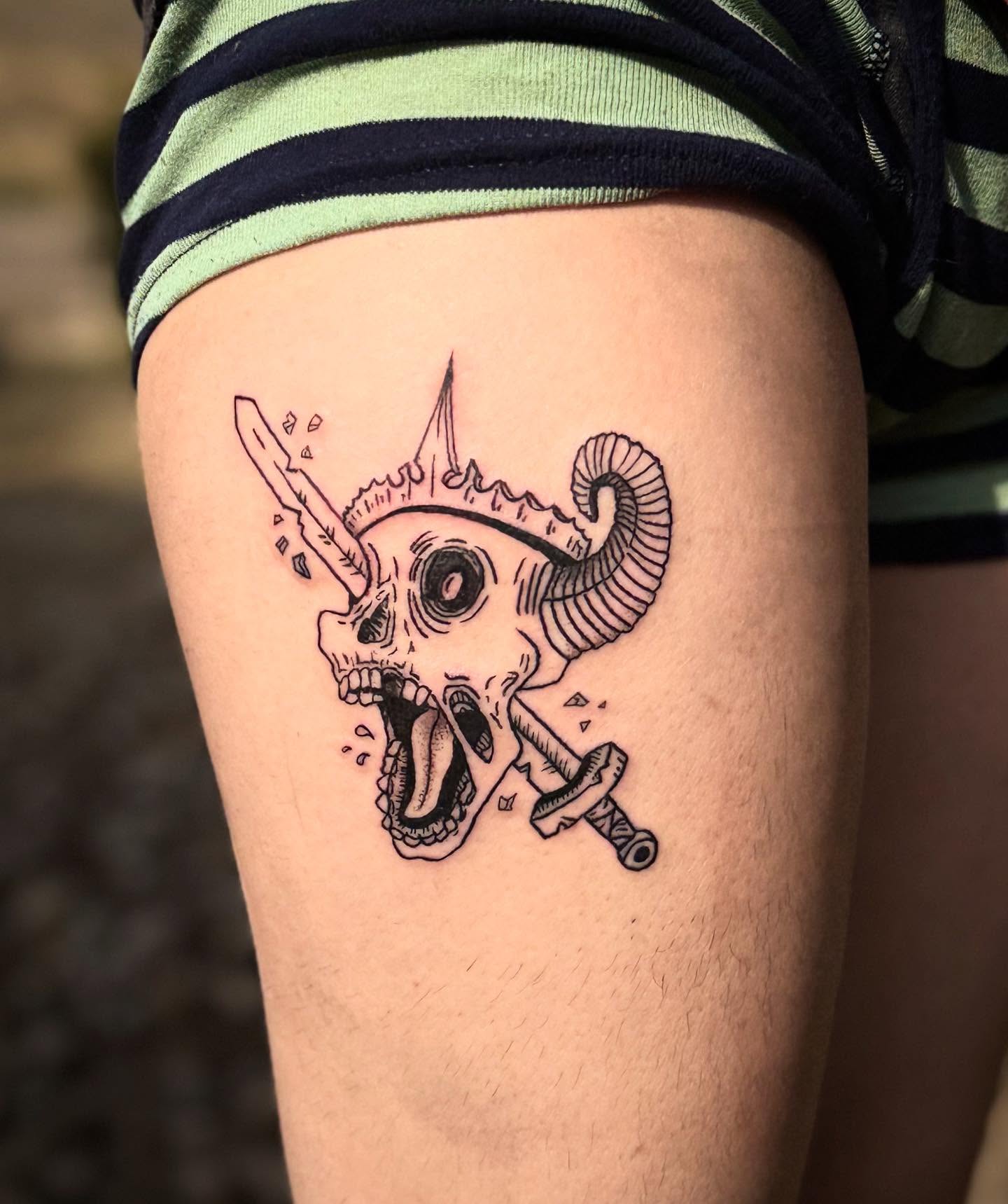 Skull with horns and sword black and grey tattoo on the thigh by Cullen-Lee