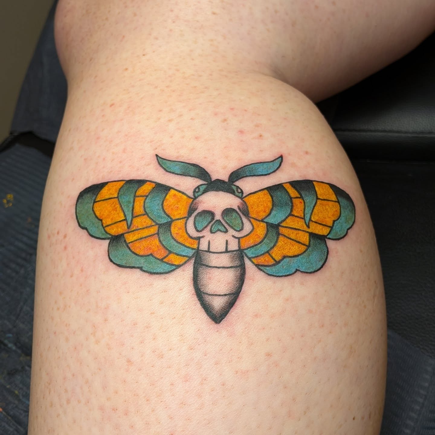 Moth with skull American traditional tattoo on the thigh by Kam
