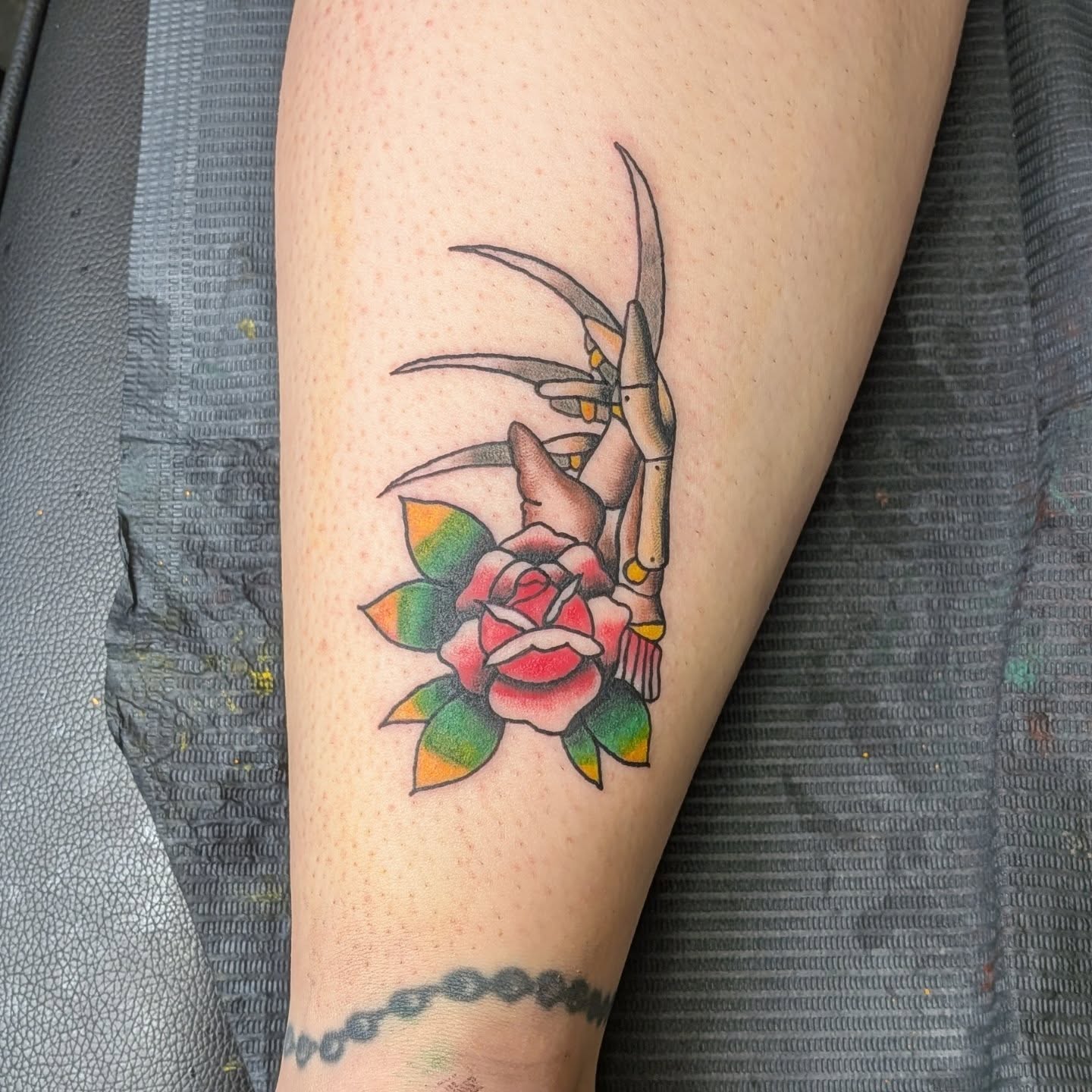 Rose and scythe American traditional tattoo on the forearm by Kam