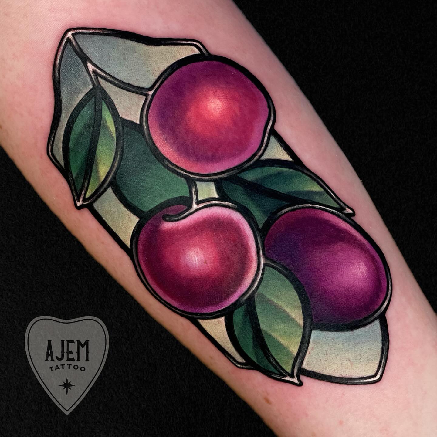 Cherries American traditional tattoo on the forearm by Ash MacIsaac