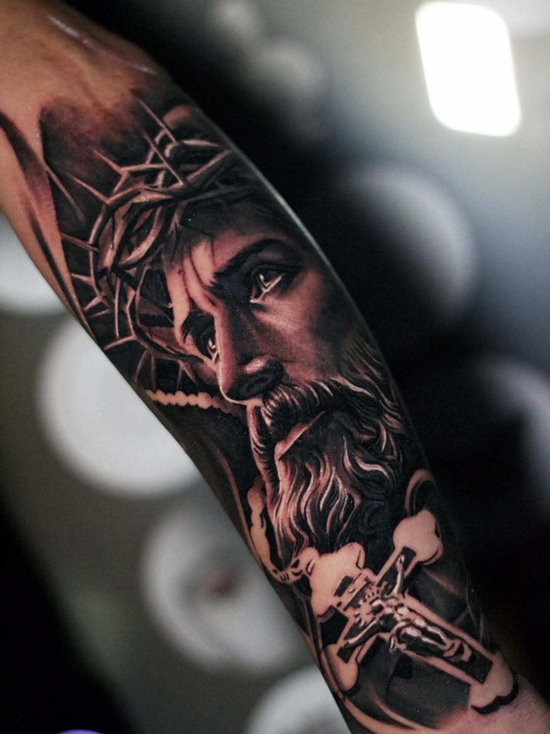 Jesus Christ portrait with cross realism tattoo on the forearm by Bapone