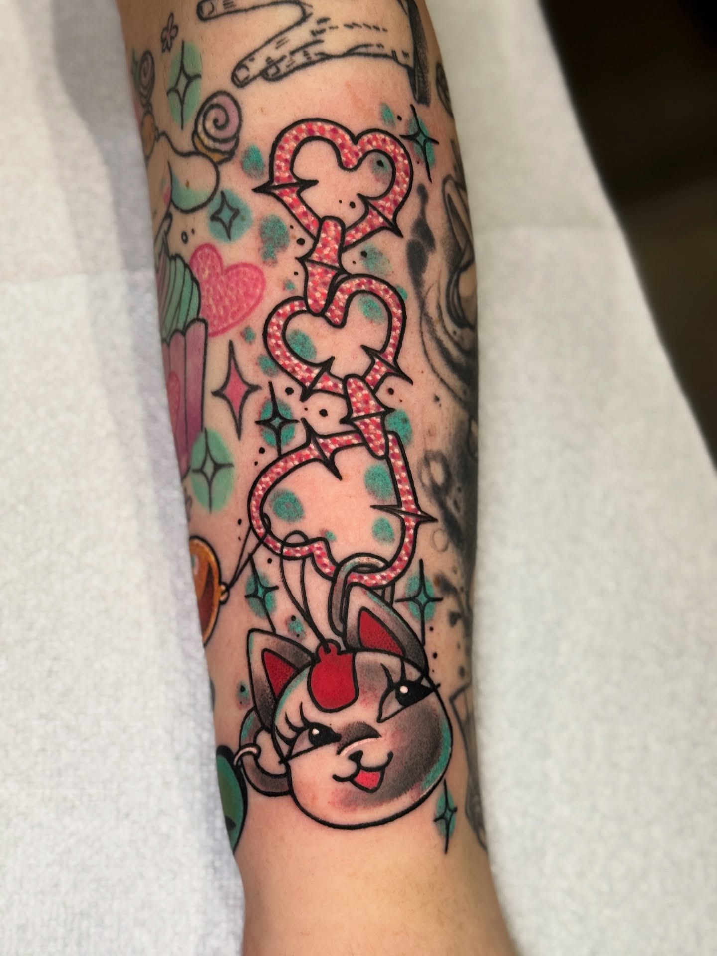 Cat with hearts new school tattoo on the forearm by ⓒⓨⓡⓤⓢ