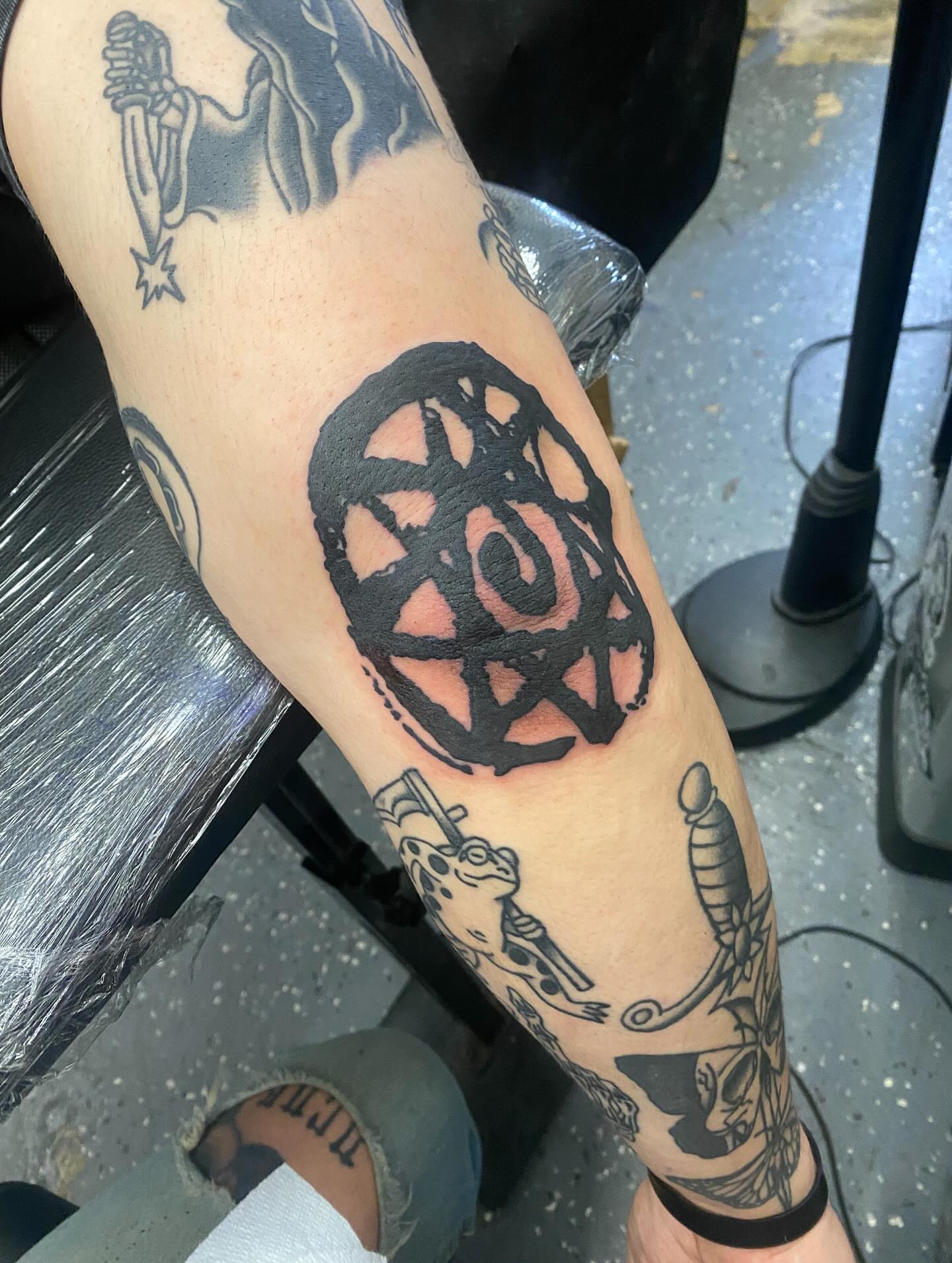 Pentagram black and grey tattoo on the forearm by Payton Prentice