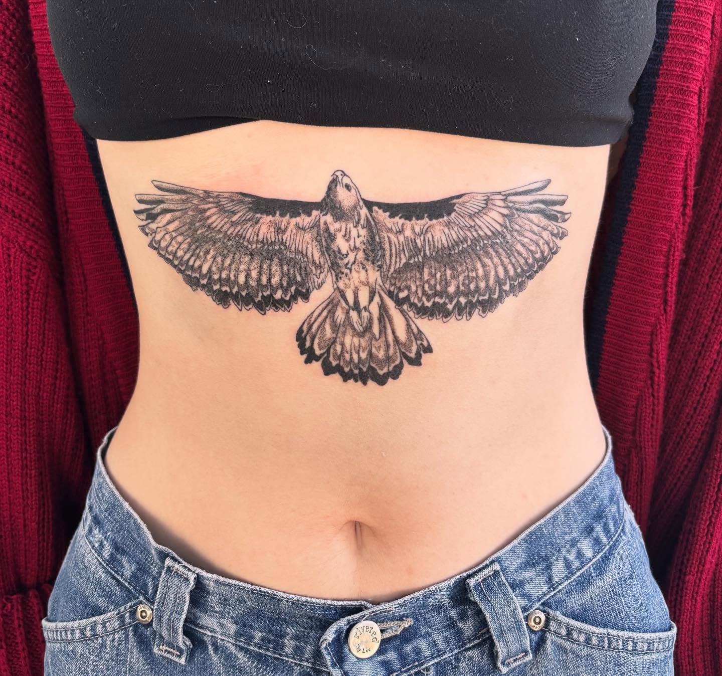 Hawk black and grey tattoo on the torso by Ashley Ellerman