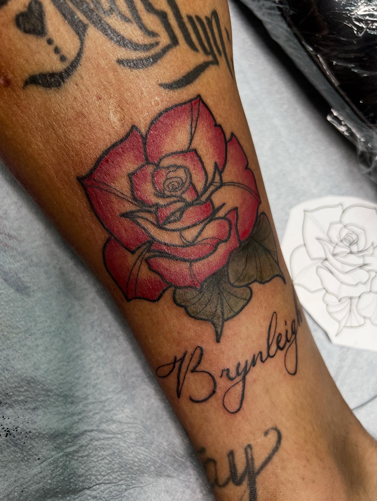 Red rose realism tattoo on the forearm by Monii Arreola