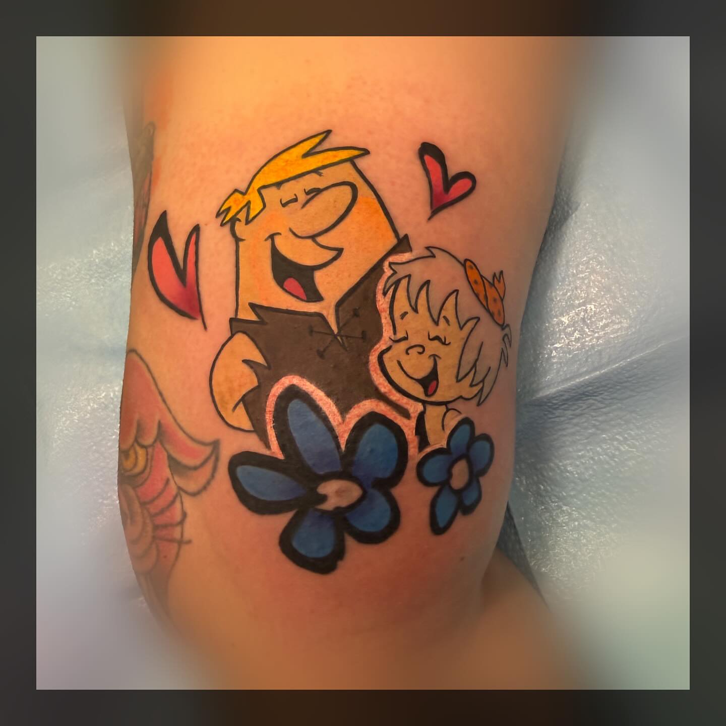 Flintstones characters new school tattoo on the thigh by Romans
