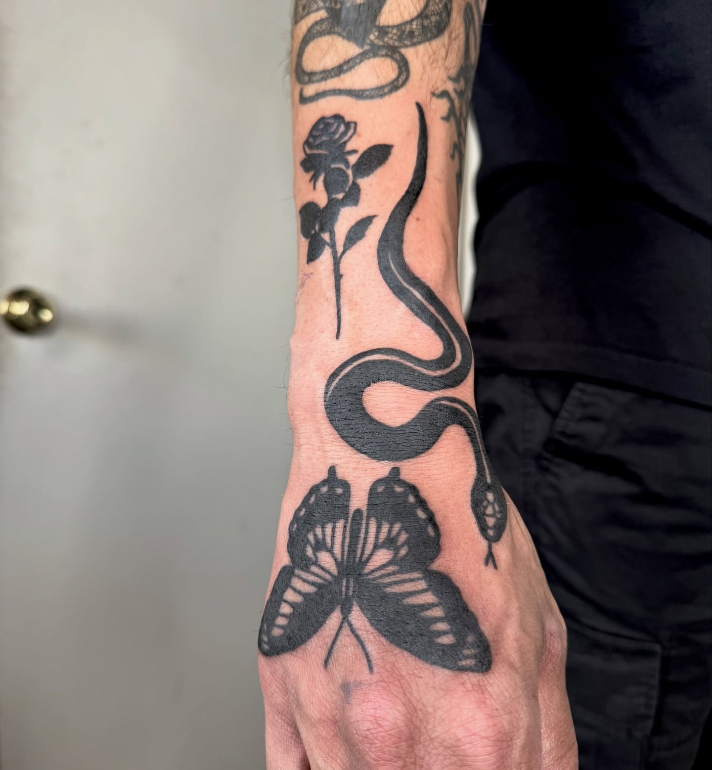 Snake and rose black and grey tattoo on the forearm by Han shinko, Portland, Oregon