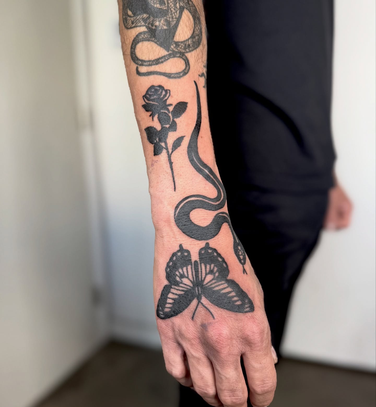 Snake and rose black and grey tattoo on the forearm by Han shinko, Portland, Oregon
