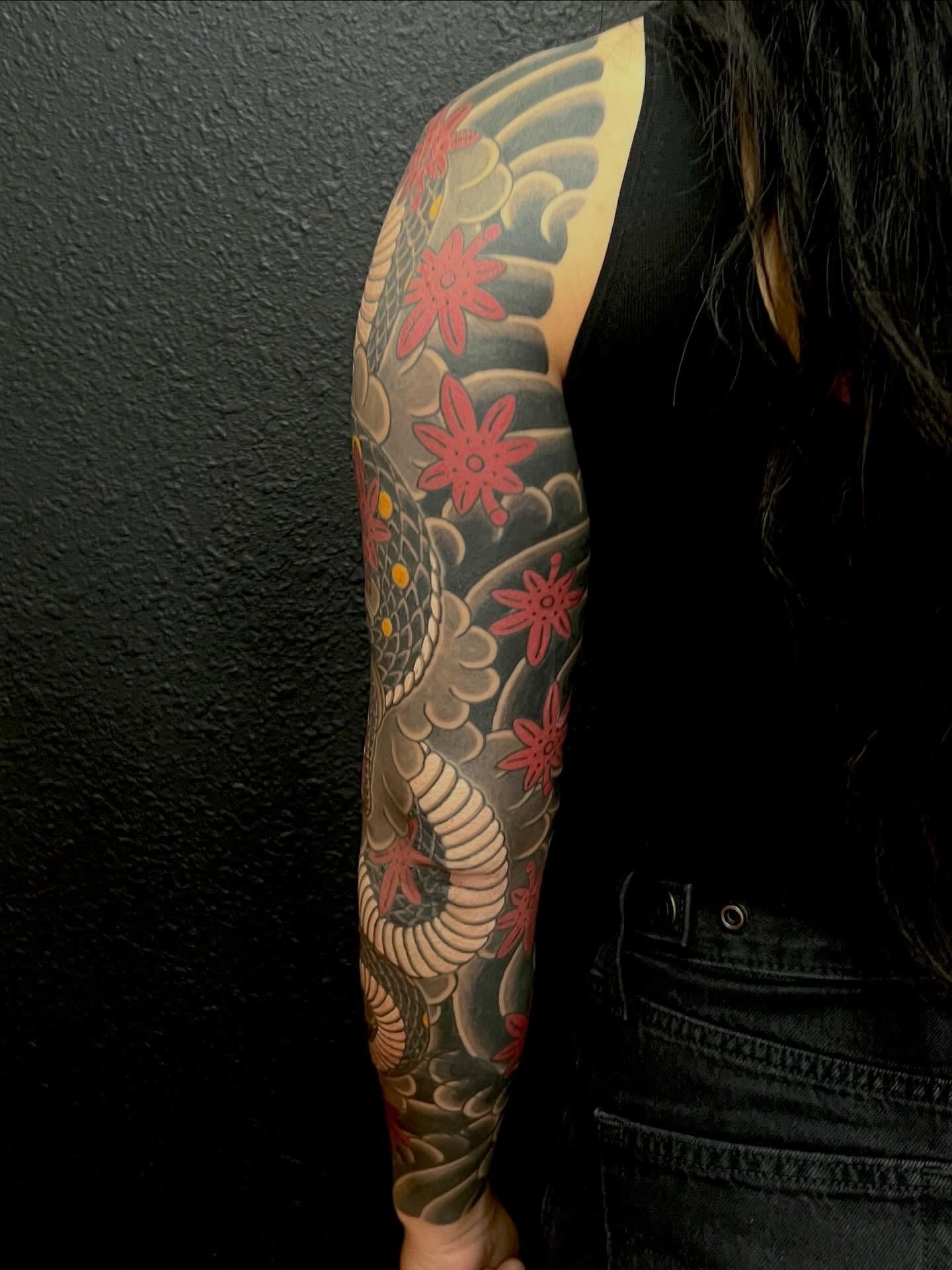 Snake and flowers japanese irezumi tattoo on the upper arm by Rocky Burley, Georgetown, Texas