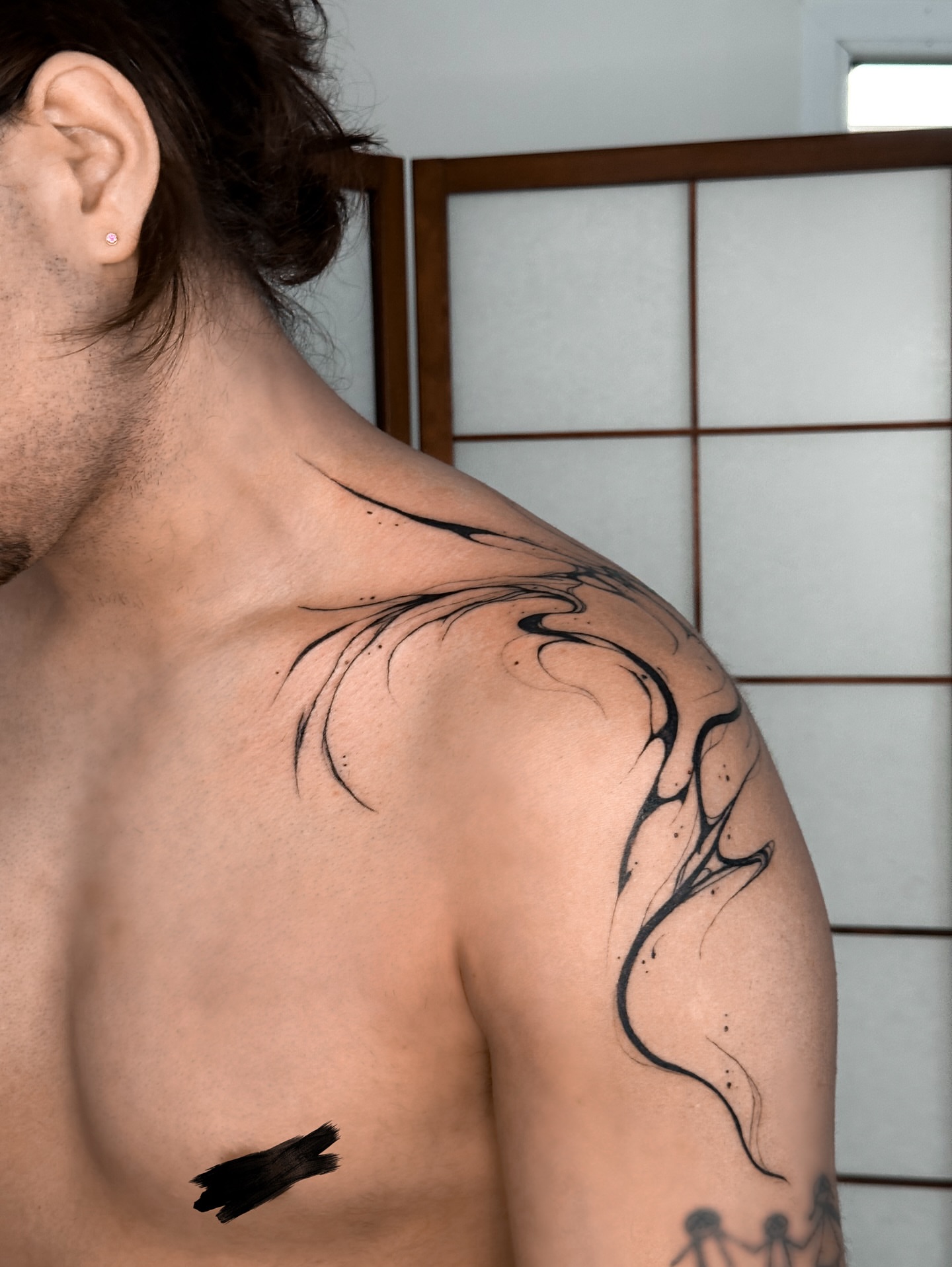 Abstract swirls black and grey tattoo on the shoulder by Mila, Riga, Latvia