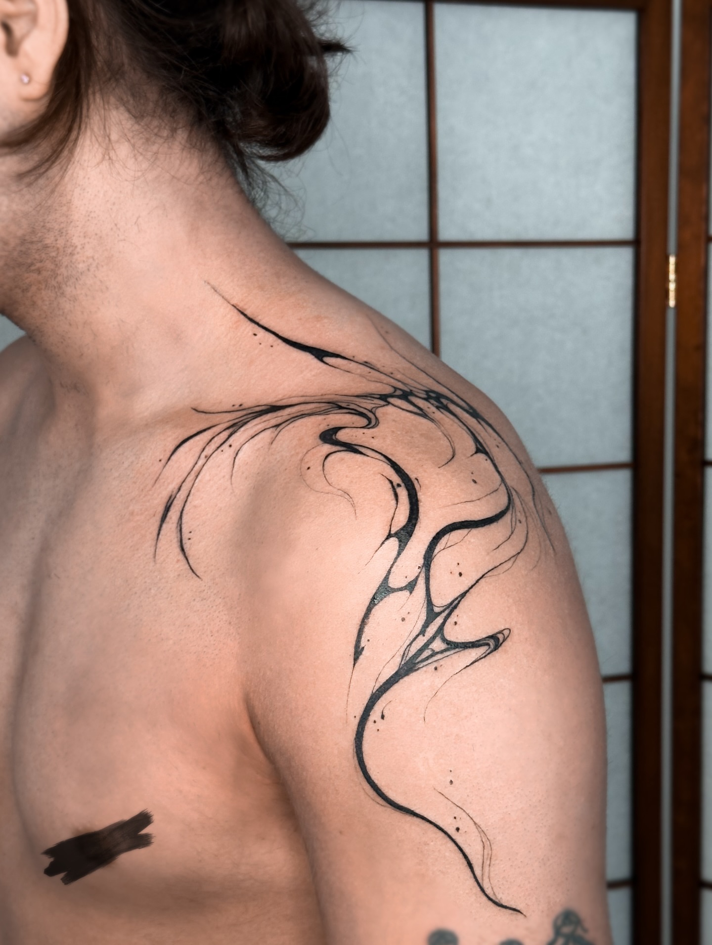 Abstract flame tribal tattoo on the shoulder by Mila, Riga, Latvia