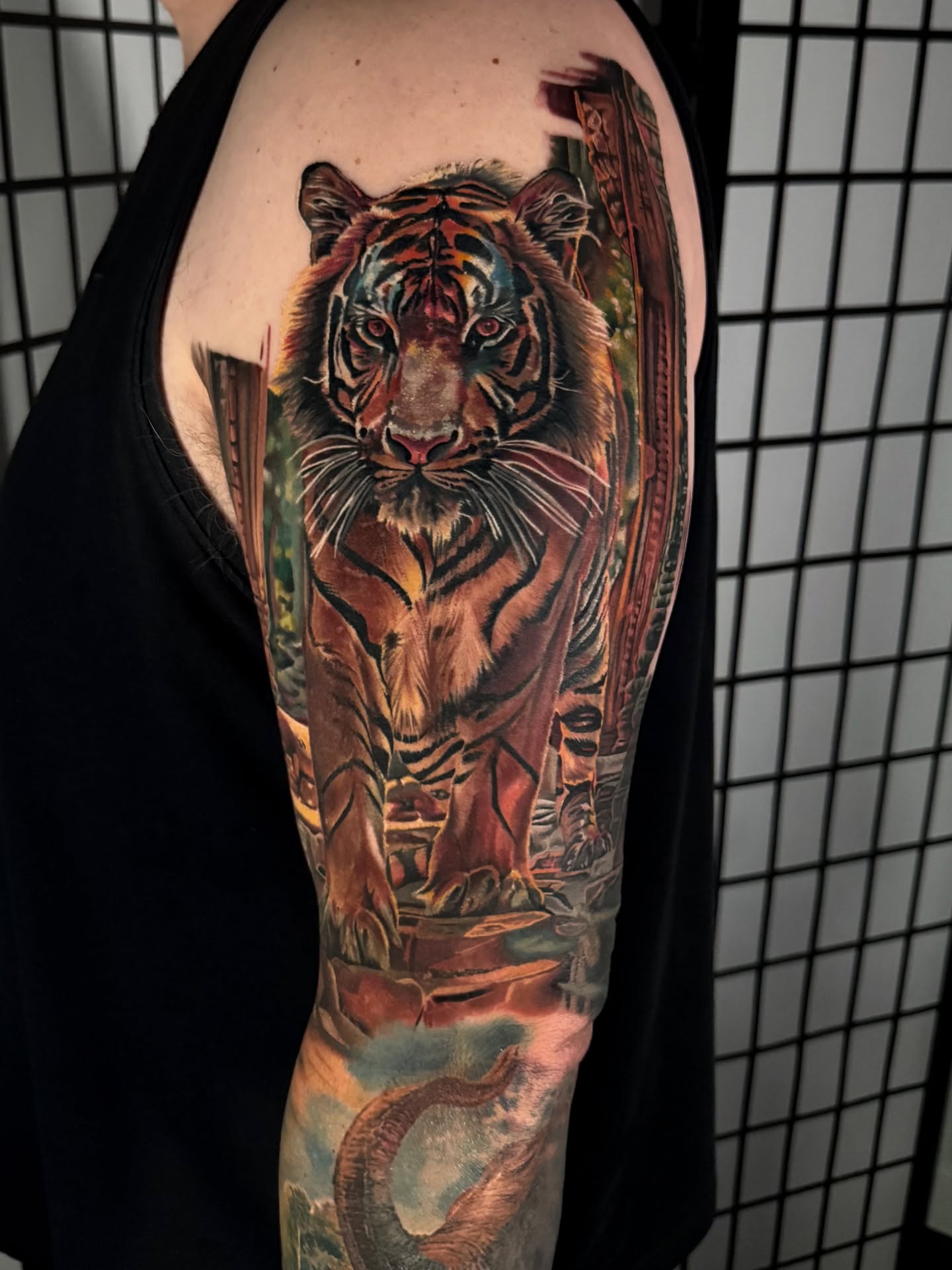 Tiger realism tattoo on the upper arm by Justin Shelpman