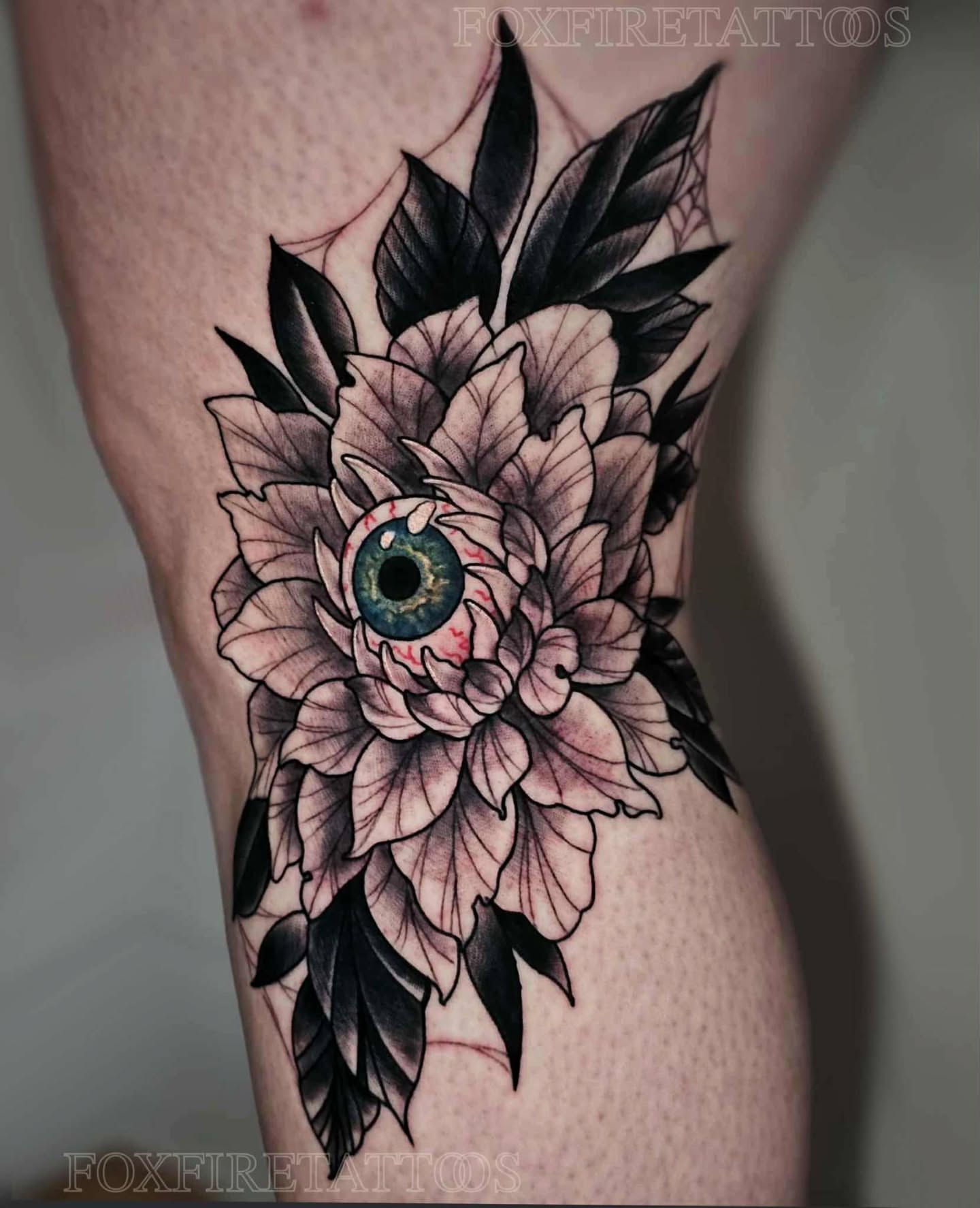 Eye with floral design dark realism tattoo on the thigh by Lindsey Chevalier - KCMO TATTOO ARTIST