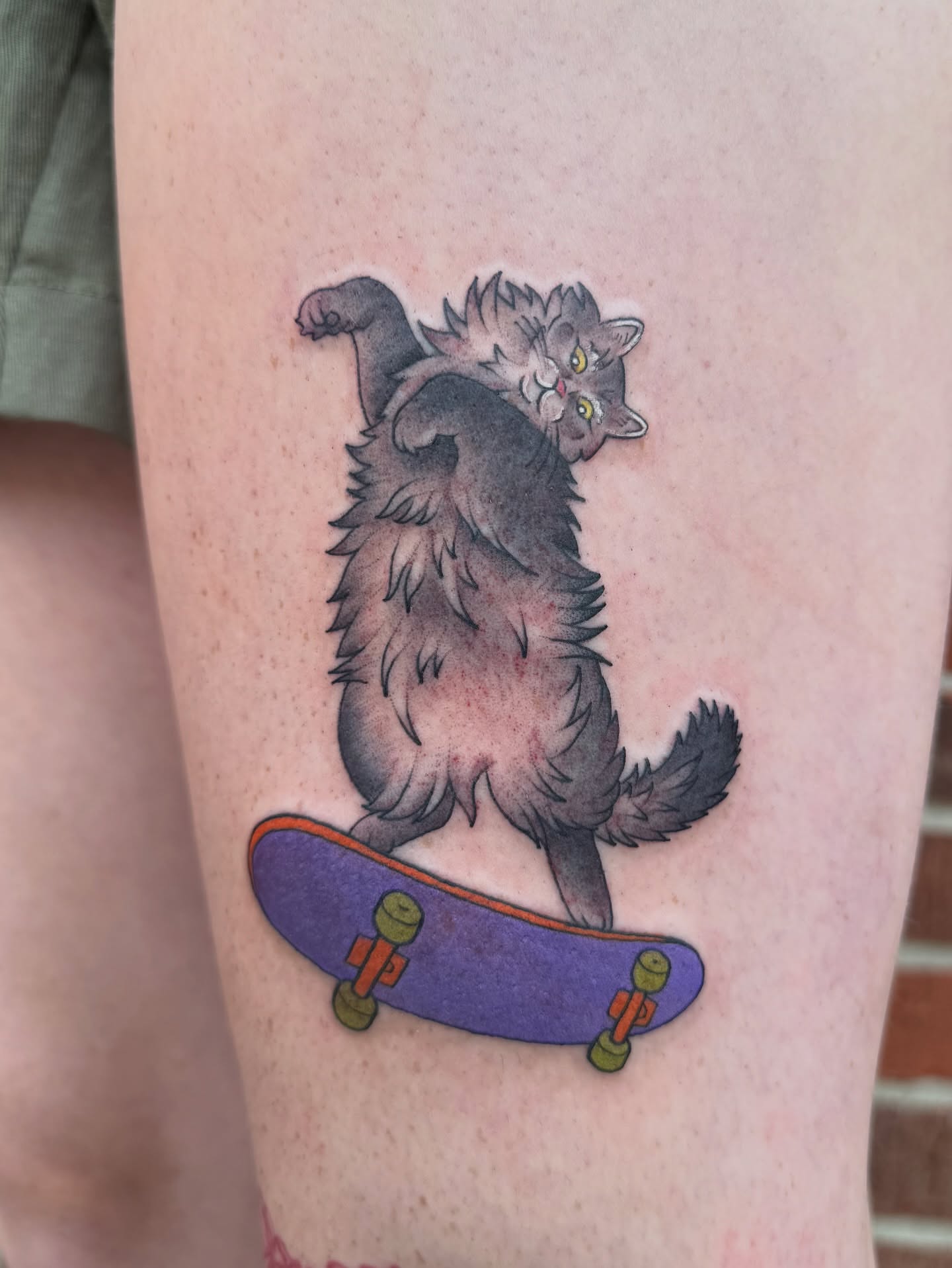 Cat on skateboard realism tattoo on the thigh by 🍄Annie Burkhard🍄, Indianapolis, Indiana