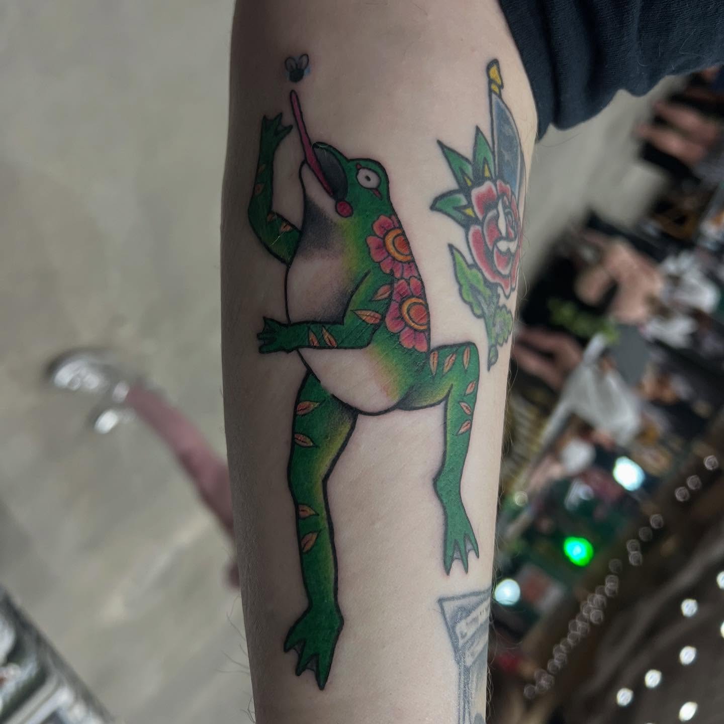 Lizard and flower American traditional tattoo on the forearm by Sav