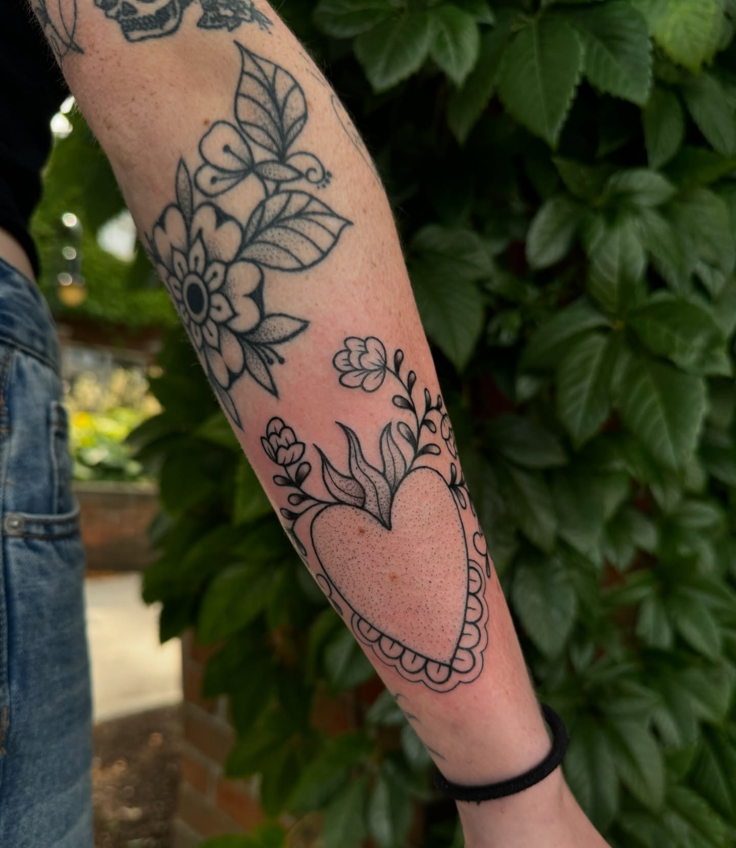 Heart with floral elements black and grey tattoo on the forearm by ꧁꧁Hayley꧂꧂