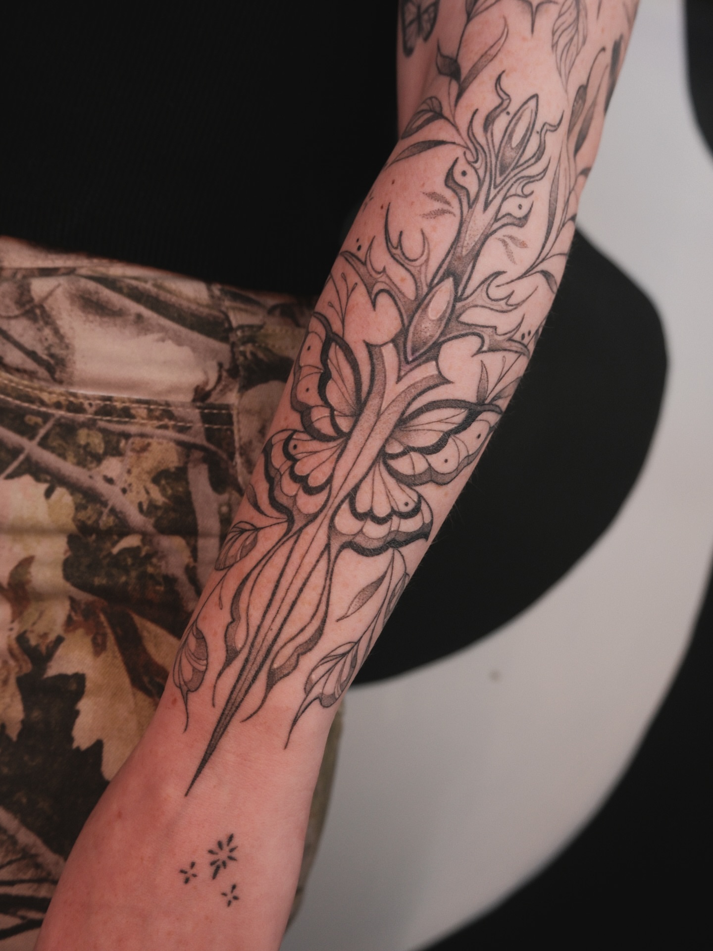 Floral design black and grey tattoo on the forearm by Velvet, Seattle, Washington