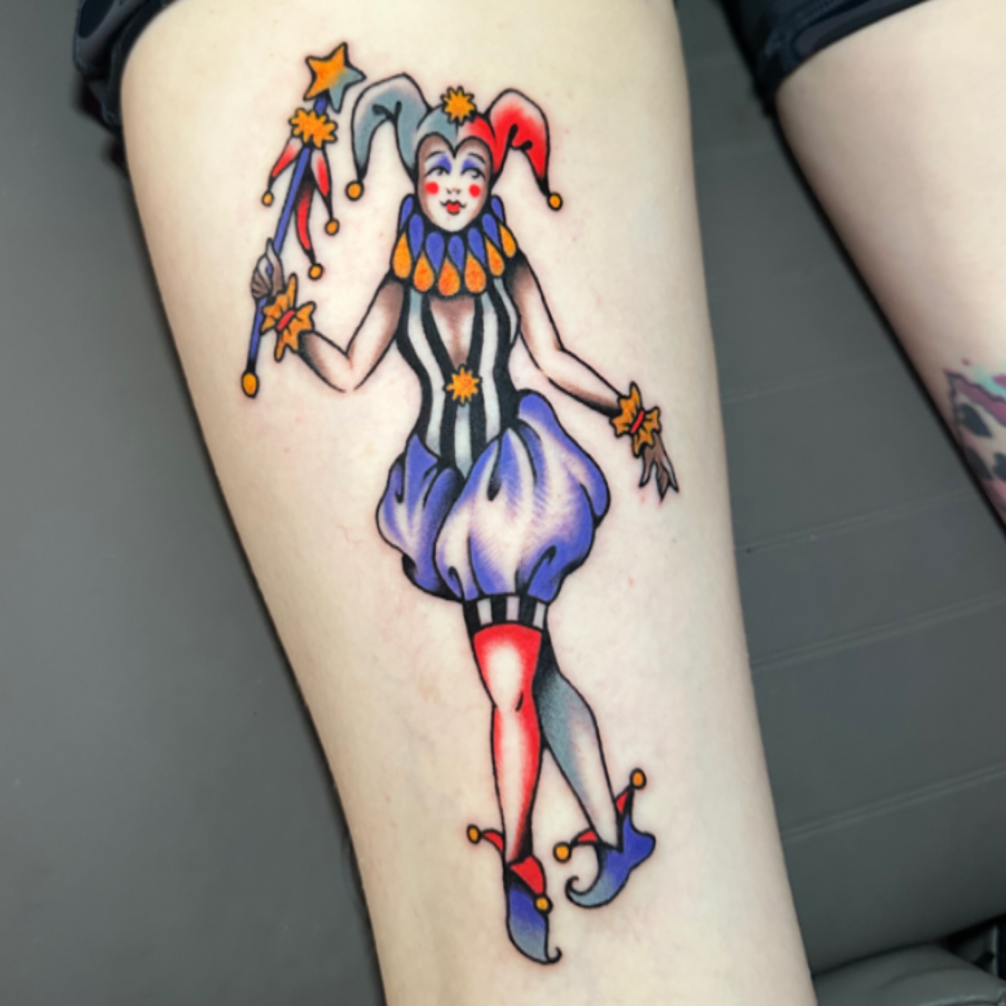 Jester American traditional tattoo on the thigh by kira