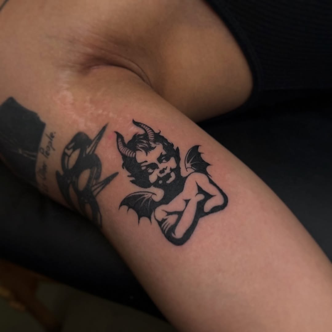 Devil cherub ignorant tattoo on the forearm by Dee, San Diego, California