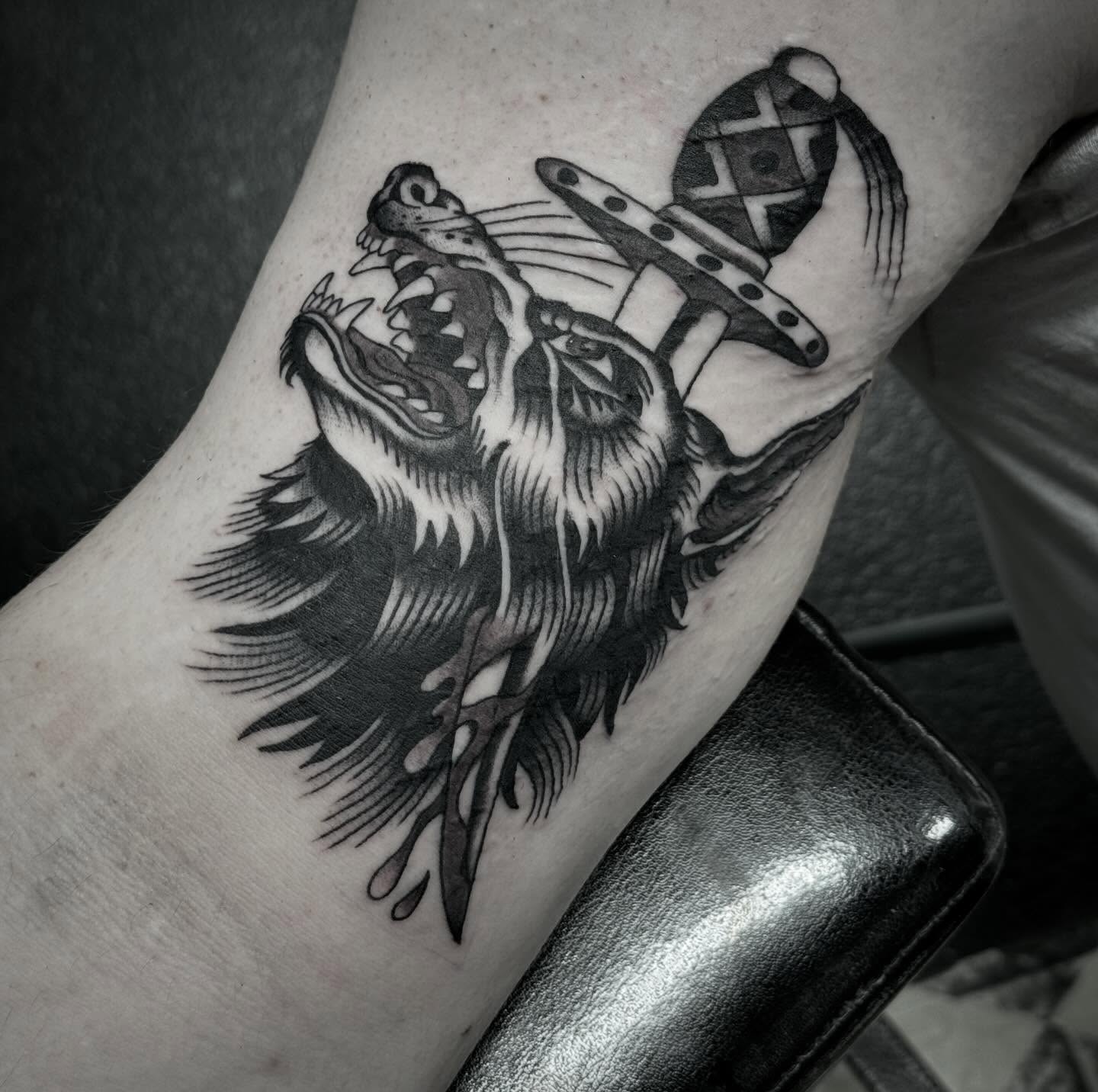 Wolf and axe realism tattoo on the forearm by Sean McMahon