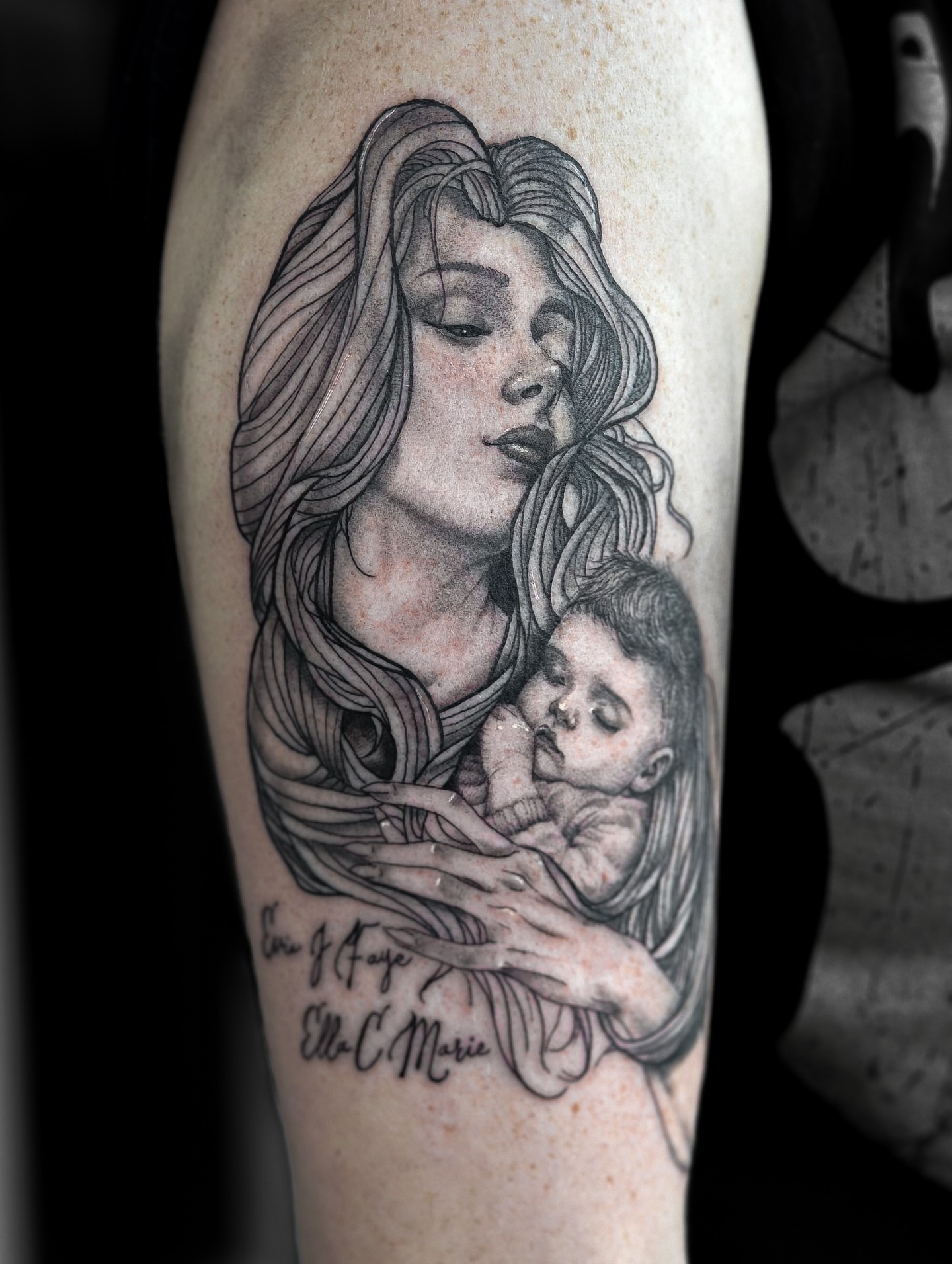 Mother and child realism tattoo on the forearm by Sincere