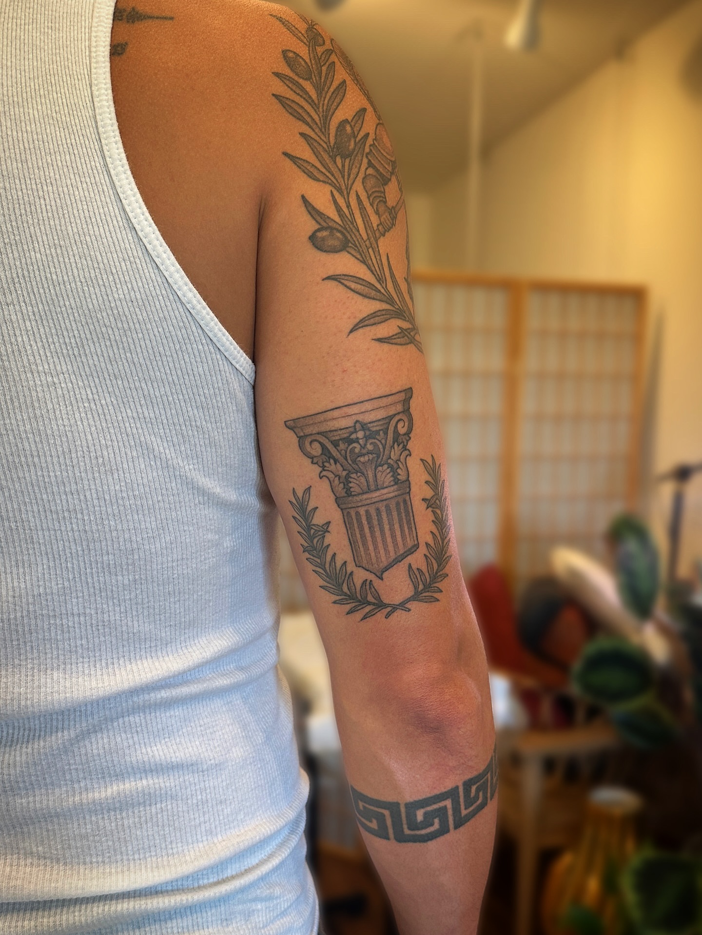 Ancient column and laurel wreath black and grey tattoo on the forearm by Tattooing by Patty Valentine