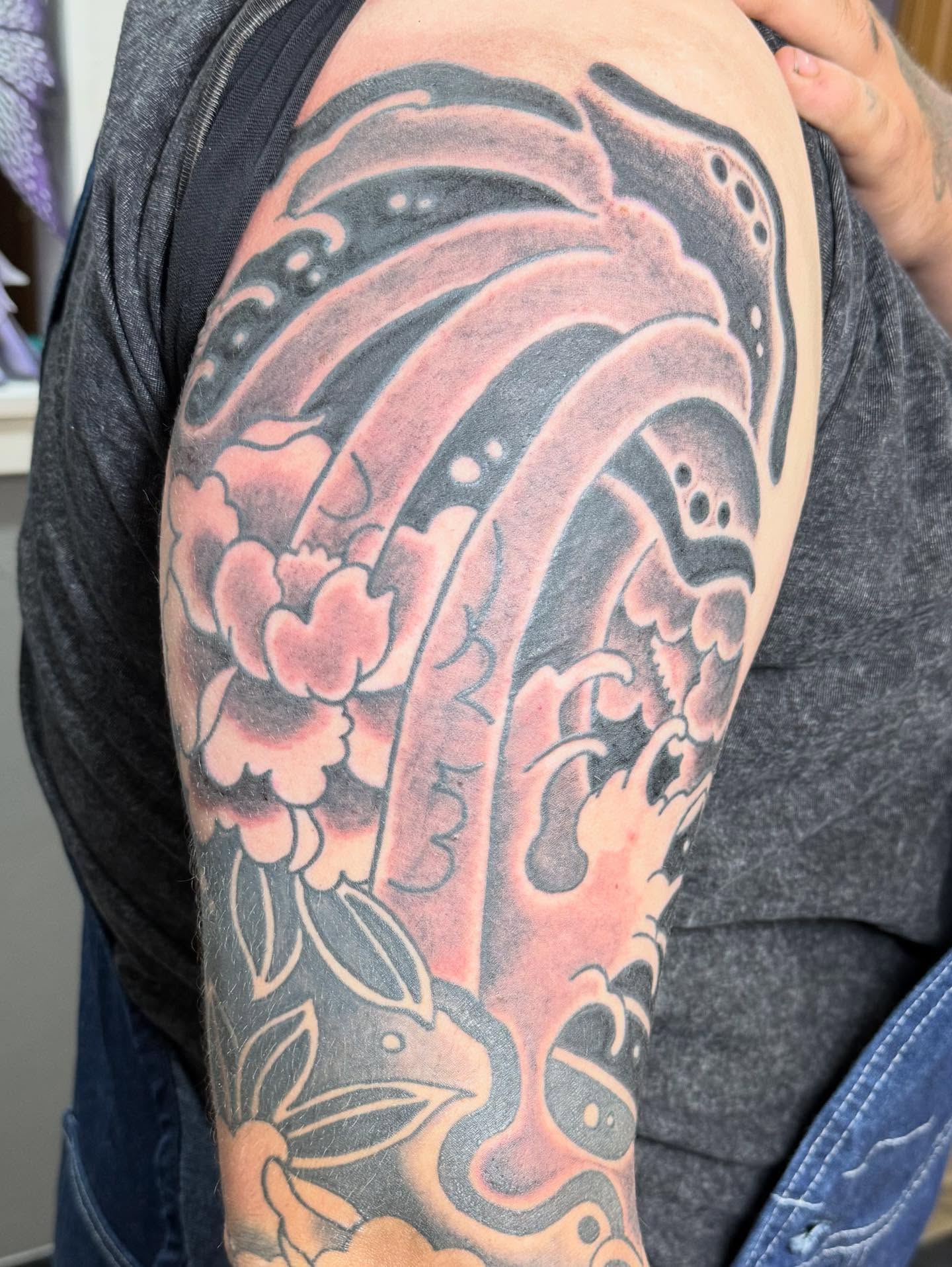 Dragon and wave japanese irezumi tattoo on the upper arm by Hunter Beyer