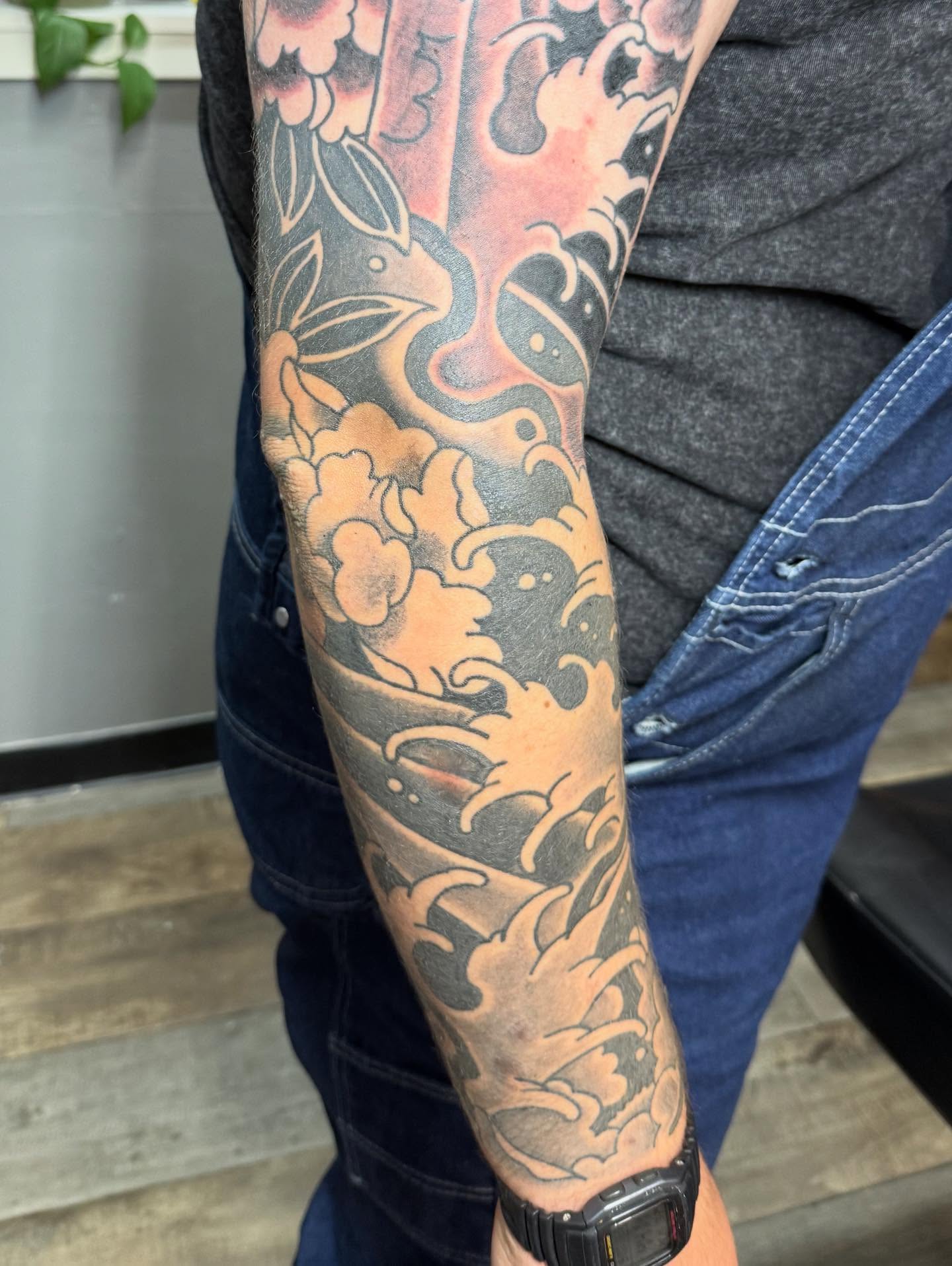 Floral wave japanese irezumi tattoo on the forearm by Hunter Beyer