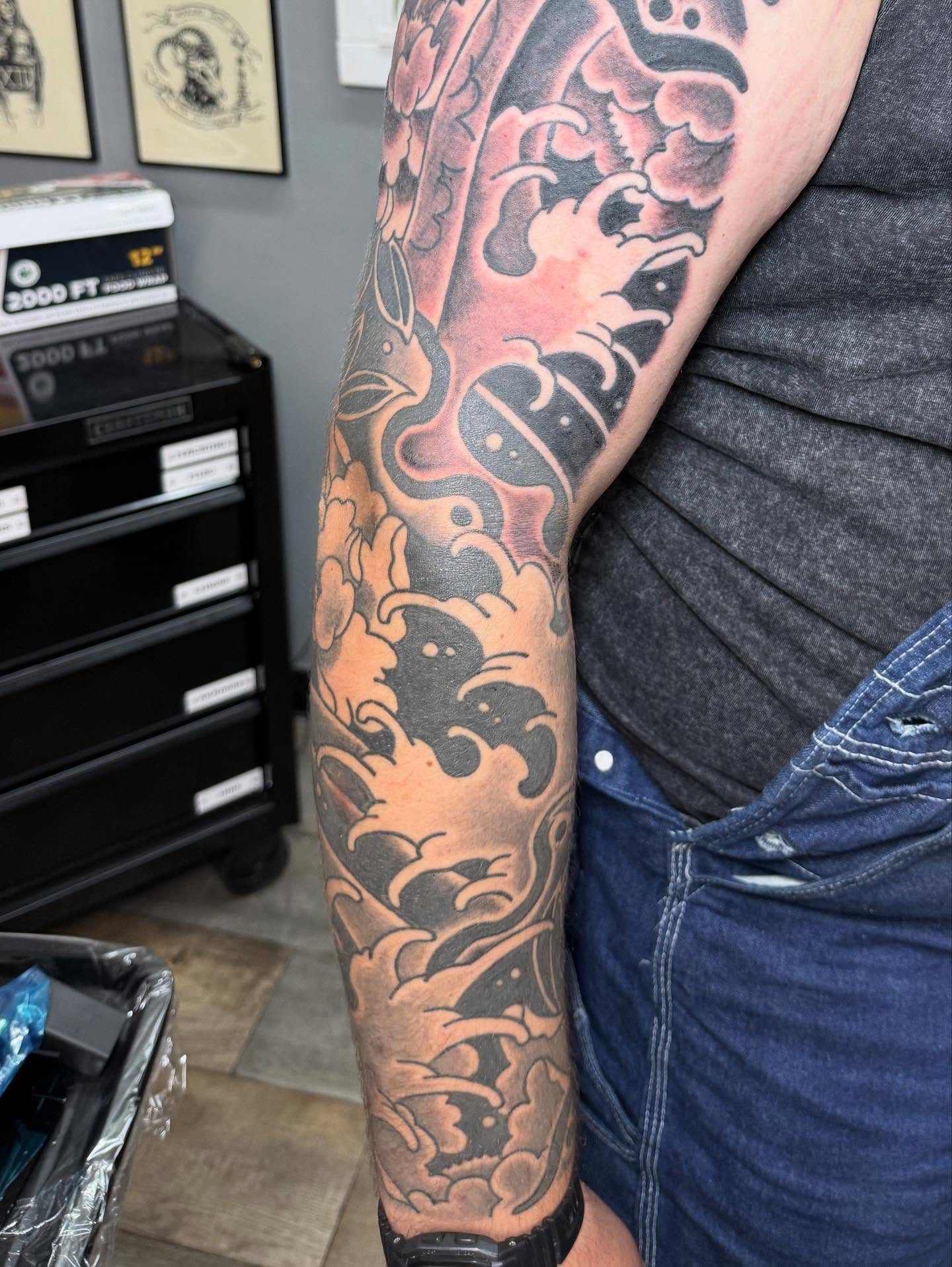Lion and clouds japanese irezumi tattoo on the forearm by Hunter Beyer