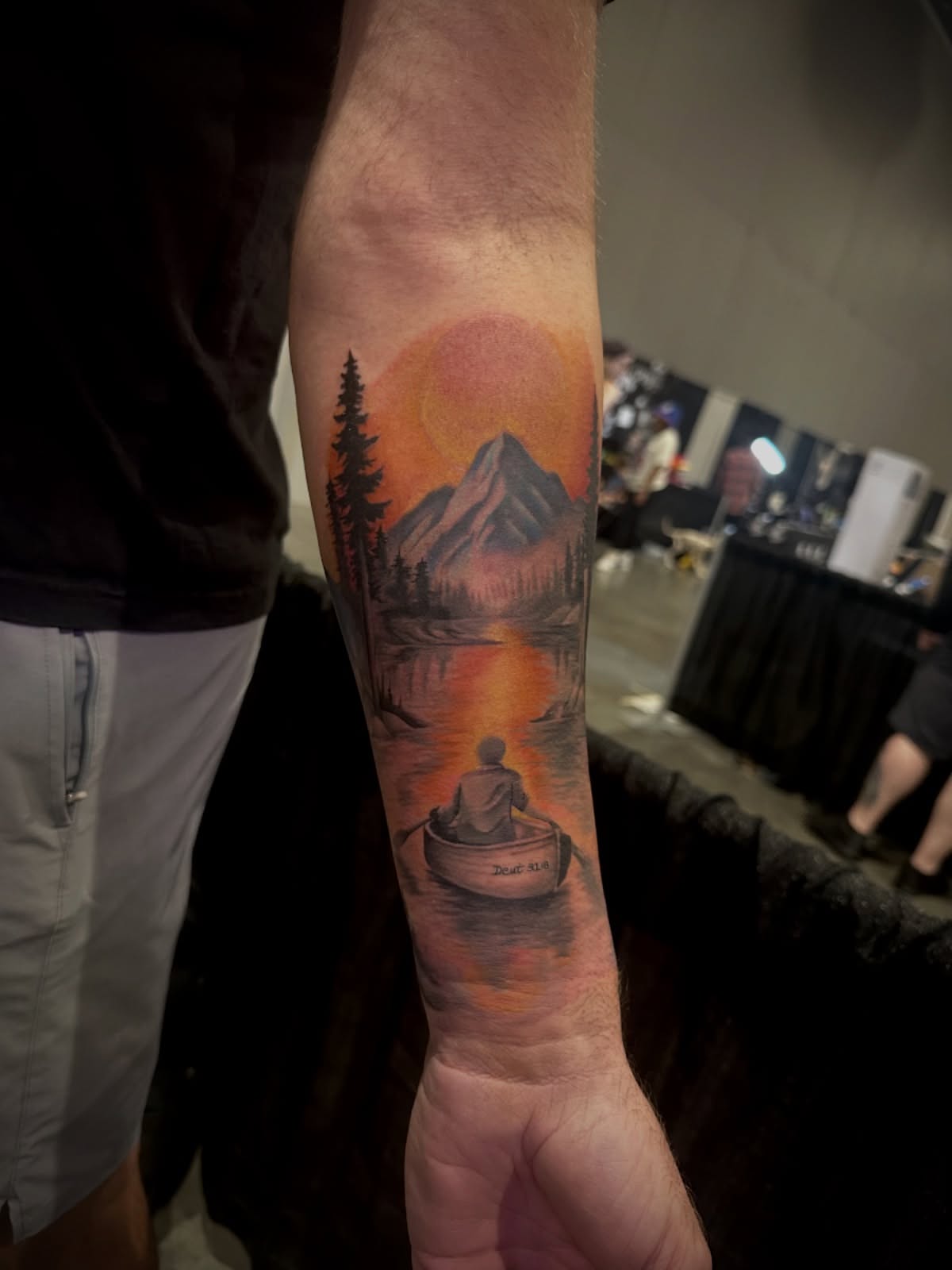 Boat and sunset realism tattoo on the forearm by Elizabeth’s Eclectic Tattoos