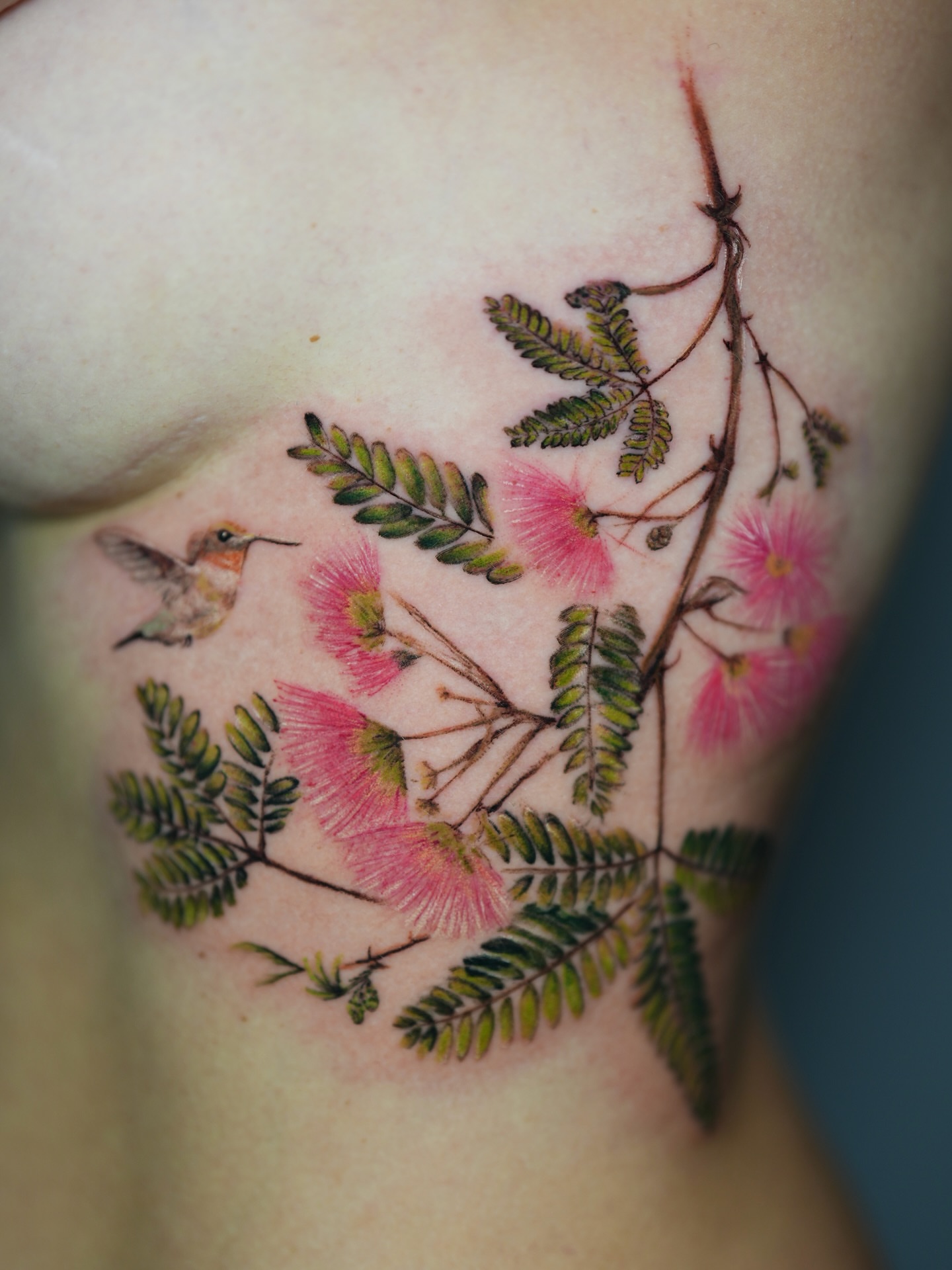 Bird and flowers realism tattoo on the chest by Henry