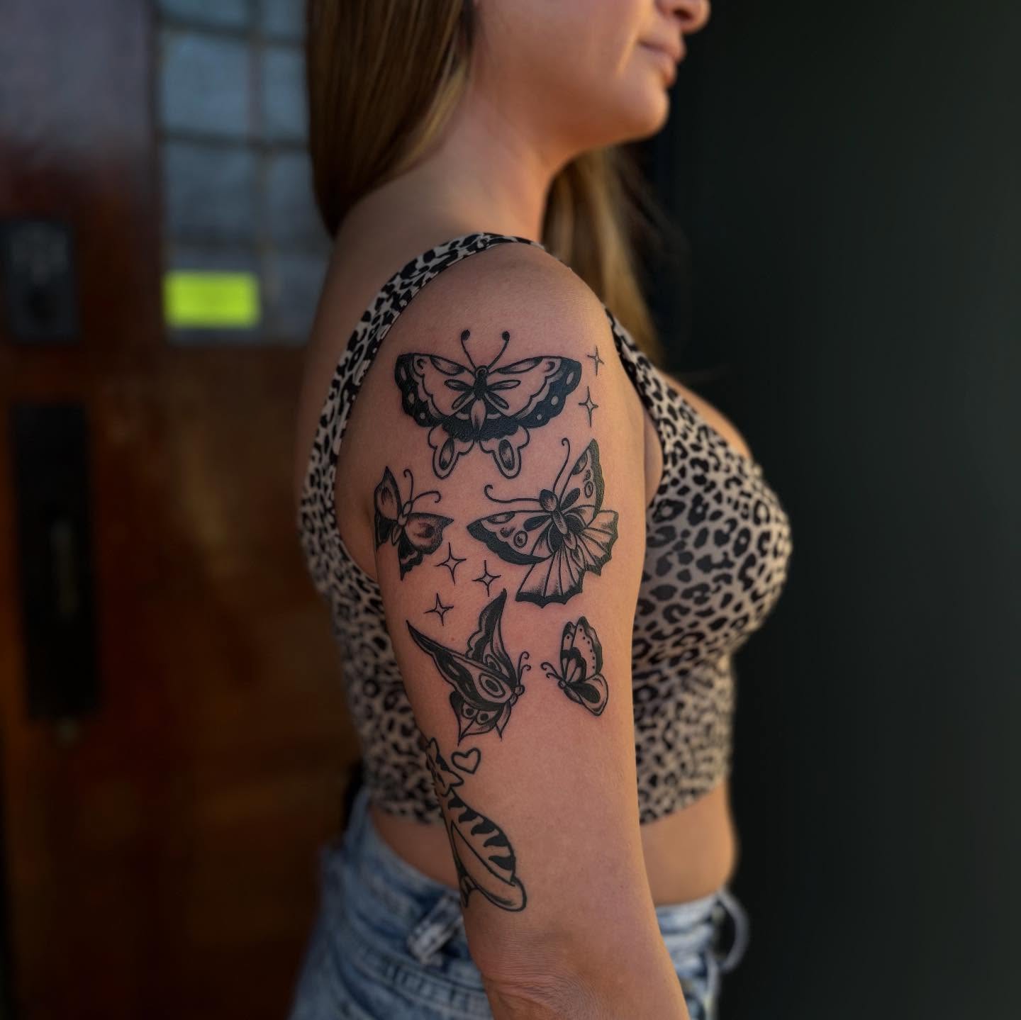 Butterflies black and grey tattoo on the shoulder by Lauren Deets