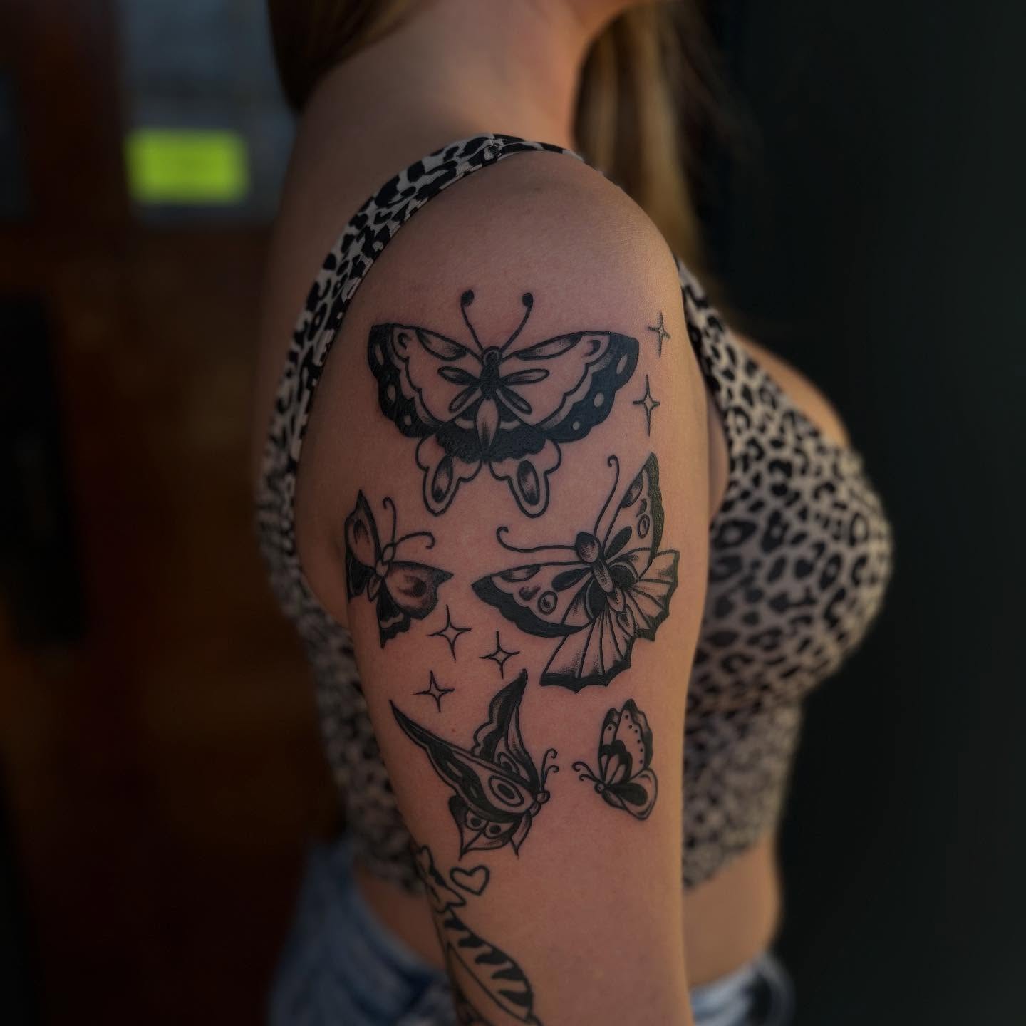 Butterflies black and grey tattoo on the shoulder by Lauren Deets