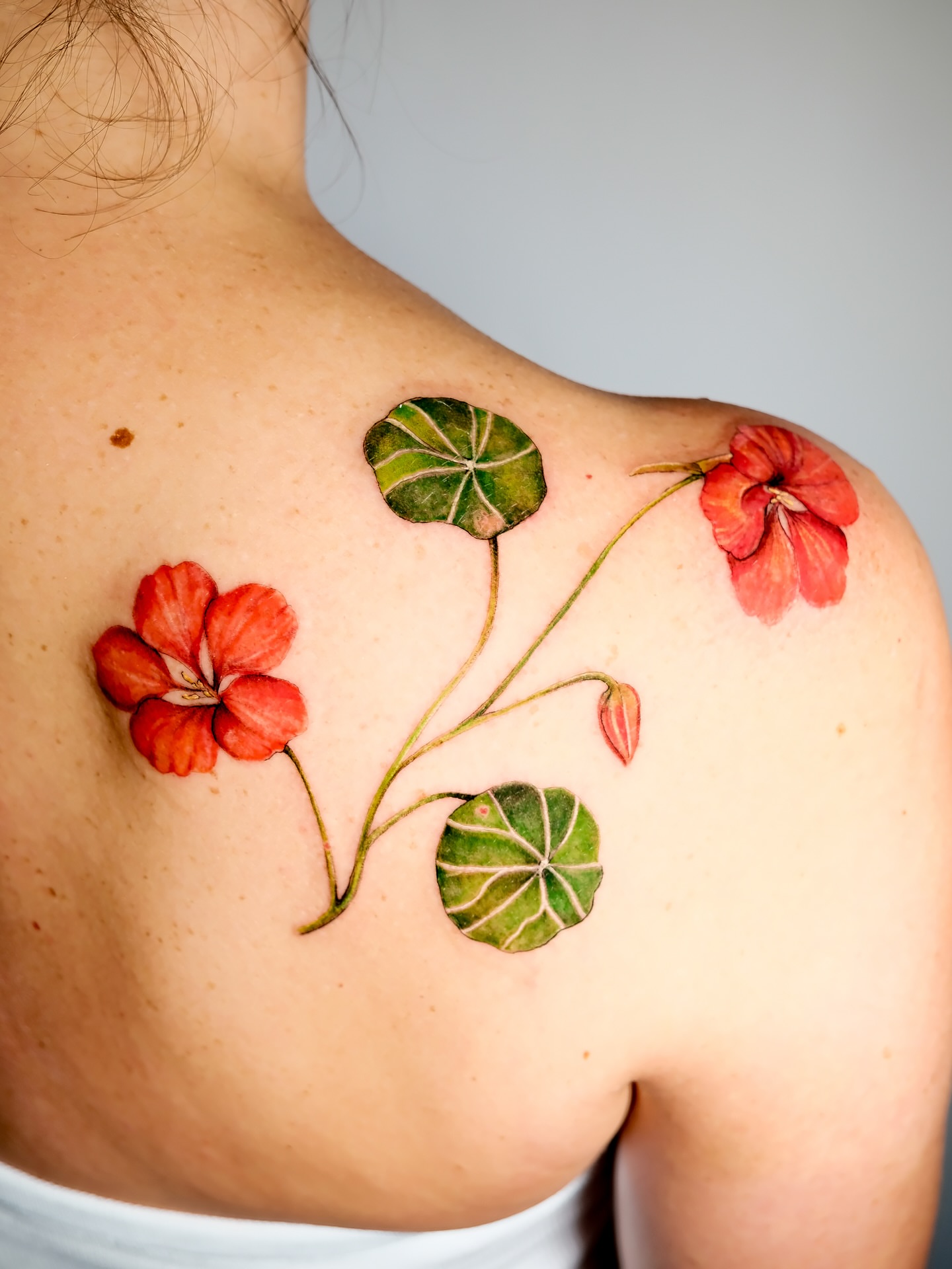 Flowers and leaves realism tattoo on the shoulder by NAS