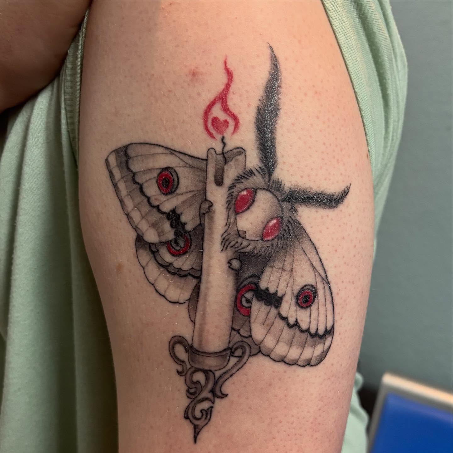 Moth and candle realism tattoo on the forearm by Oscar Cuéllar (Kue-Yar)